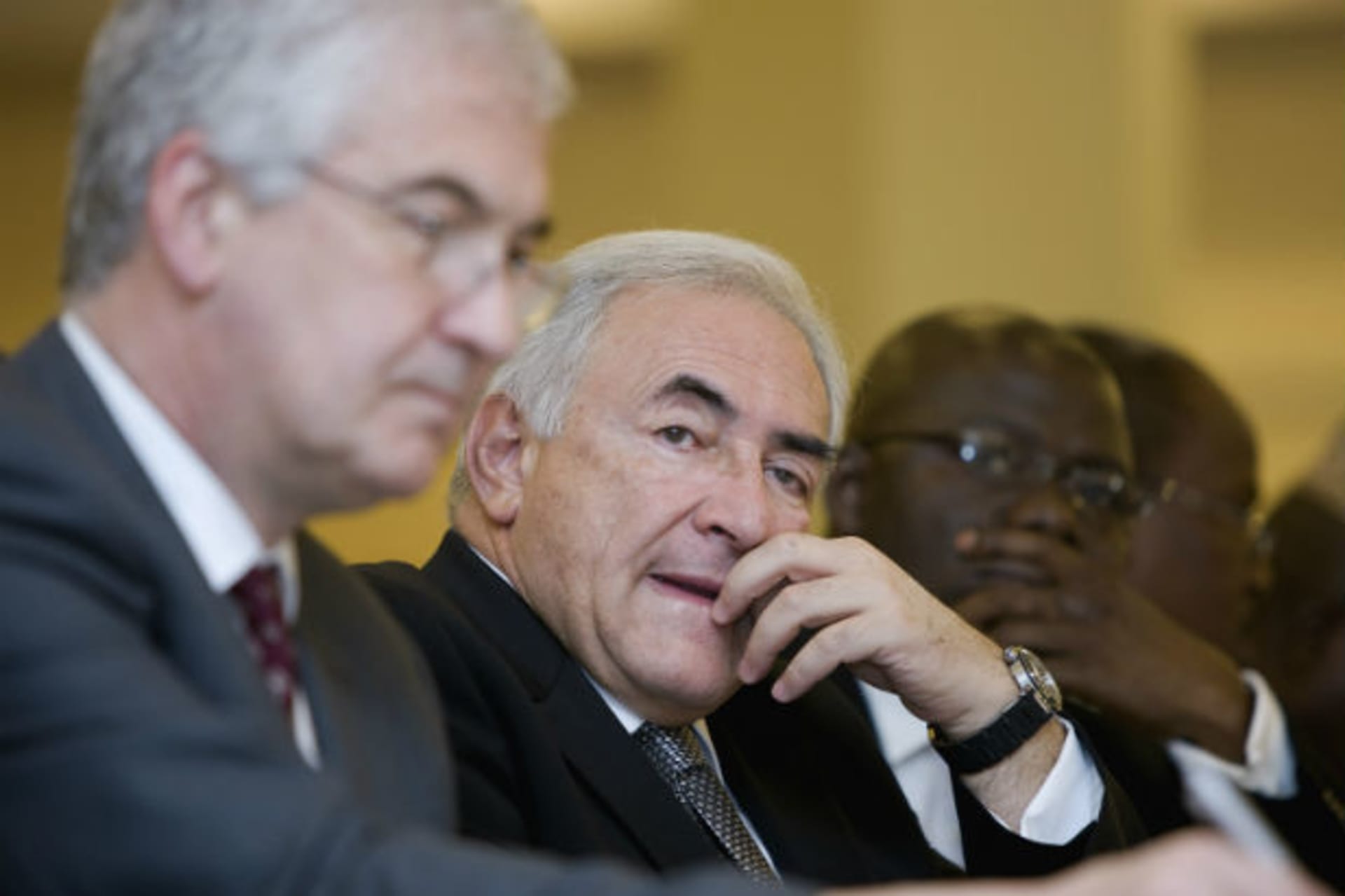 International Monetary Fund's (IMF) Managing Director Dominique Strauss-Kahn listens along side Tony Venables (L), Chief Economist for Department for International Development (DFID), and Remi Babalola (R), Nigerian Minister of State, at a work