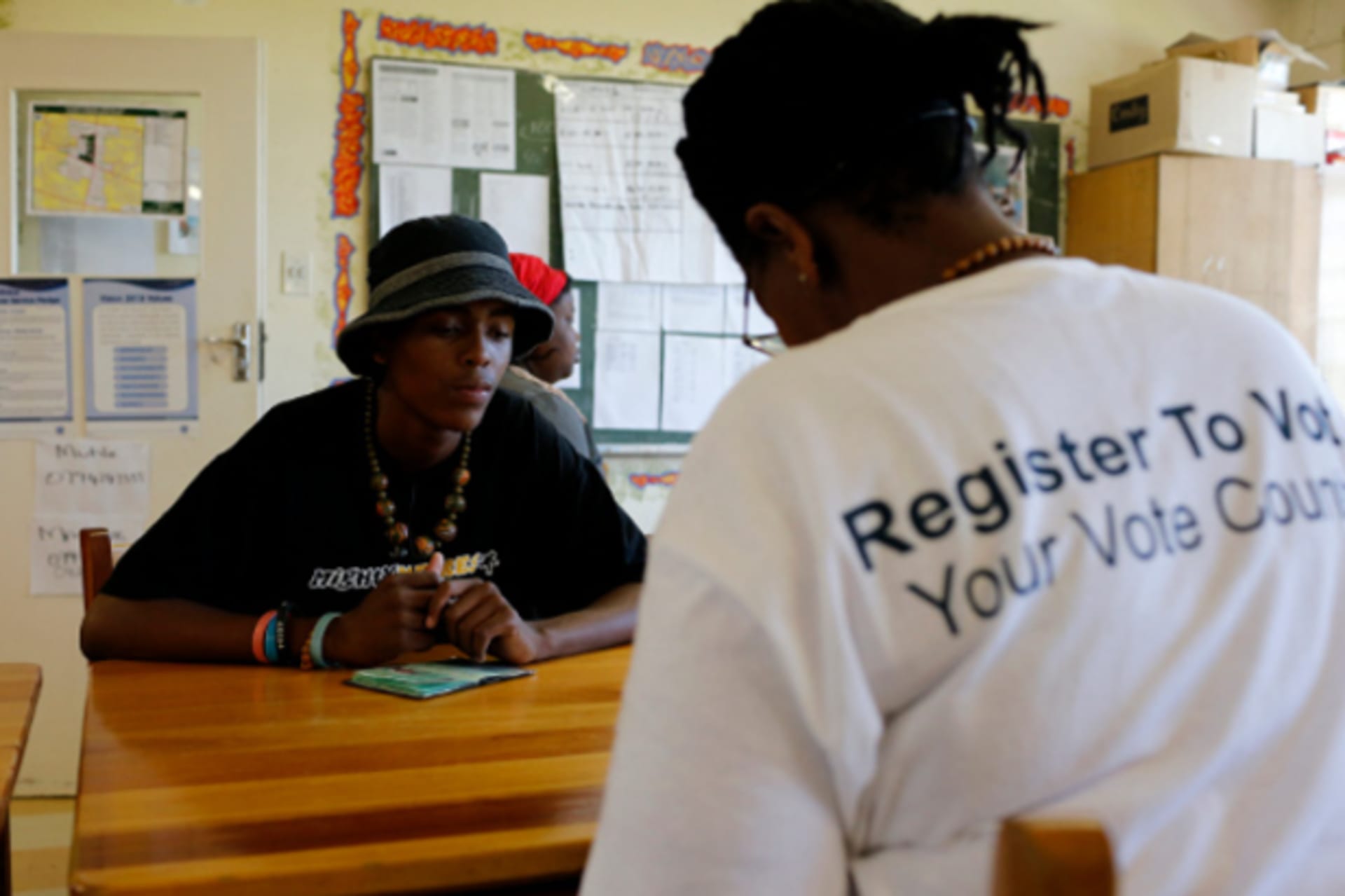 Election officials assist Khulasande Matabese, 18, as he registers to cast his ballot in elections scheduled for May 7 in Cape Town's Langa township, February 8, 2014. (Mike Hutchings/Courtesy Reuters)