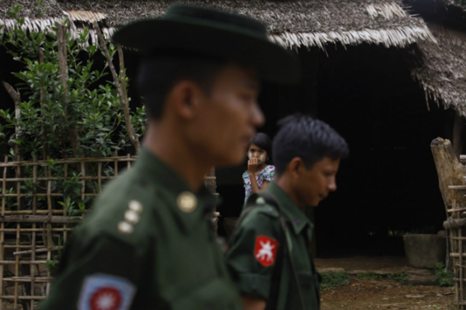 <p>A Muslim girl watches from the doorway of her home as soldiers walk by in Thapyuchai village, outside of Thandwe in the Rakhin…m homes and Buddhist villagers were attacked in a region plagued by intractable sectarian tensions. (Thandwe/Courtesy Reuters)</p>
