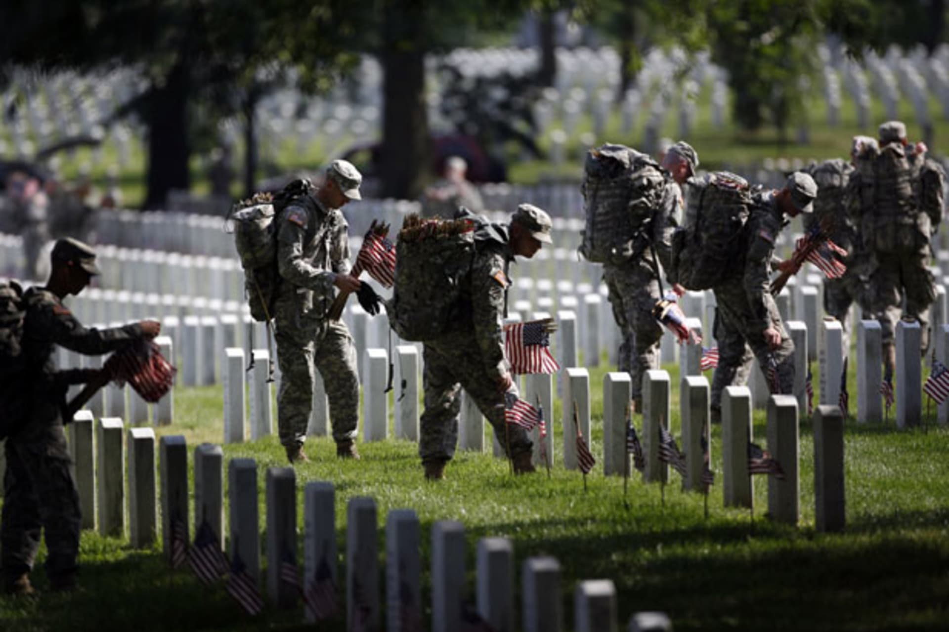 <p>Members of the U.S. Army Old Guard place a flag at each of the more than 220,000 graves at Arlington National Cemetery (Jason Reed/Courtesy Reuters).</p>
