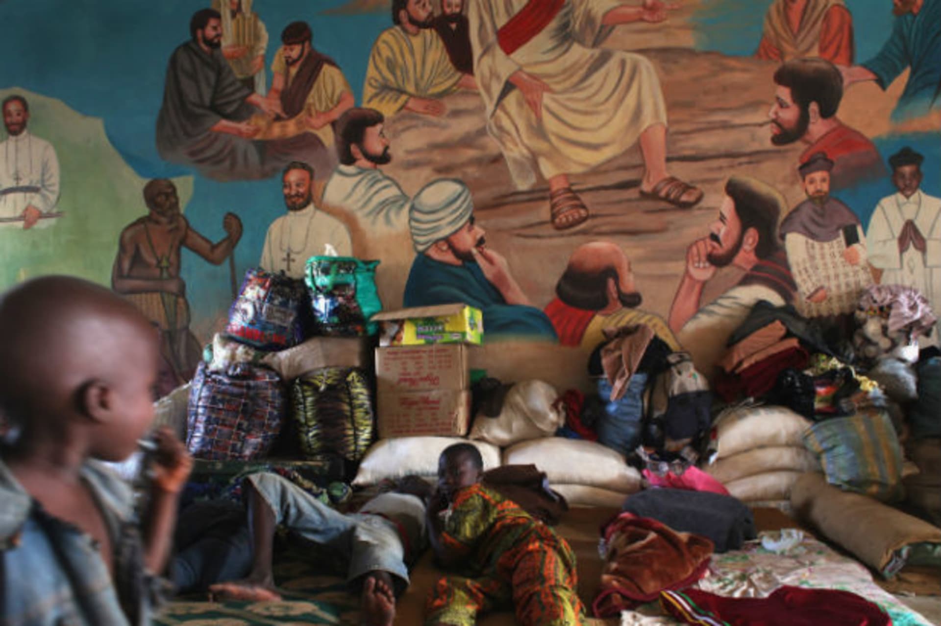 Displaced families rest next to their personal belongings as they take refugee from religious violence at the Catholic Church in Bossangao, north of capital Bangui in the Central African Republic December 29, 2013.