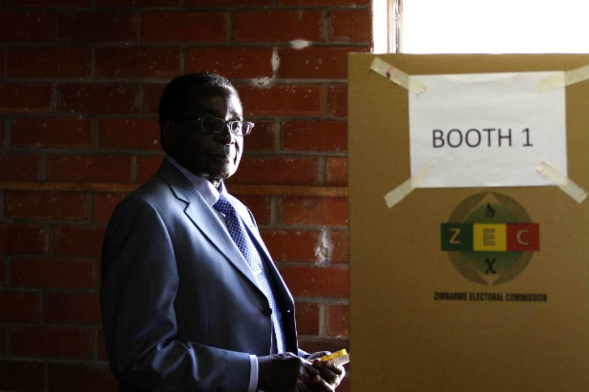 Zimbabwe's President Robert Mugabe looks on before casting his vote in Highfields outside Harare July 31, 2013.