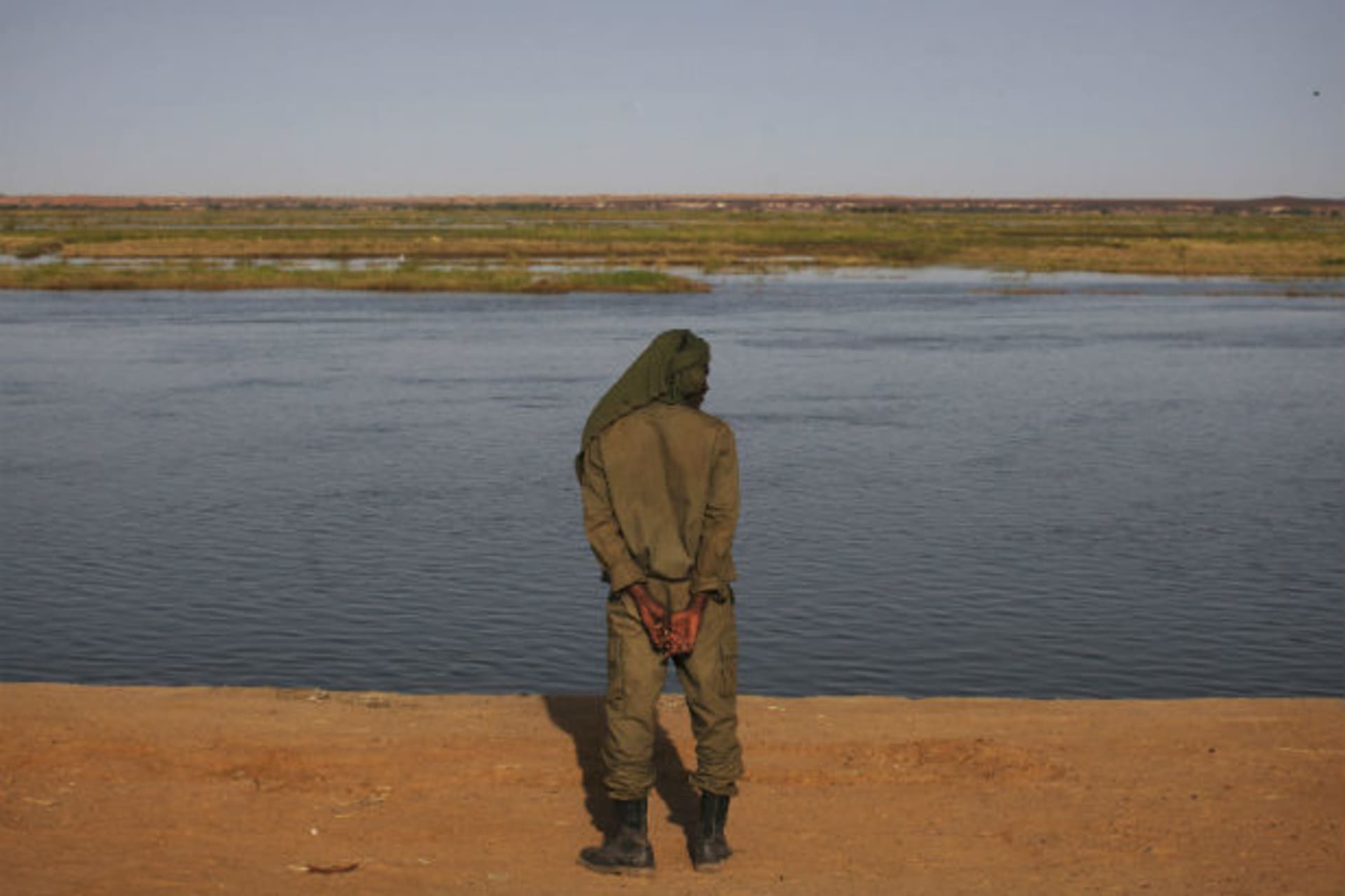 A Malian soldier looks out on the banks of the Niger River in Gao February 26, 2013.