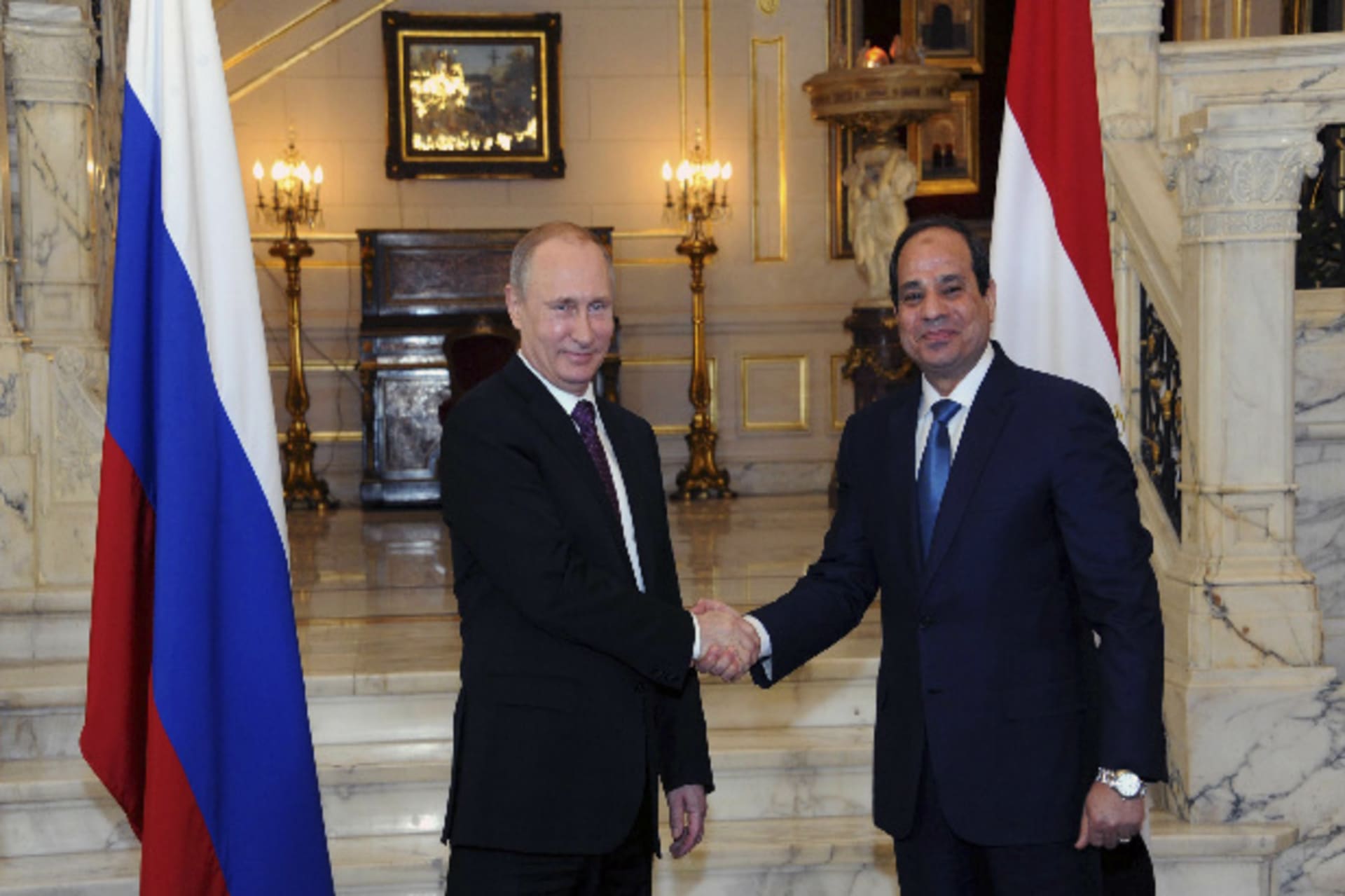 Russia's President Vladimir Putin (L) shakes hands with Egypt's President Abdel Fattah al-Sisi during a meeting in Cairo February 10, 2015 (Klimentyev/Courtesy Reuters).