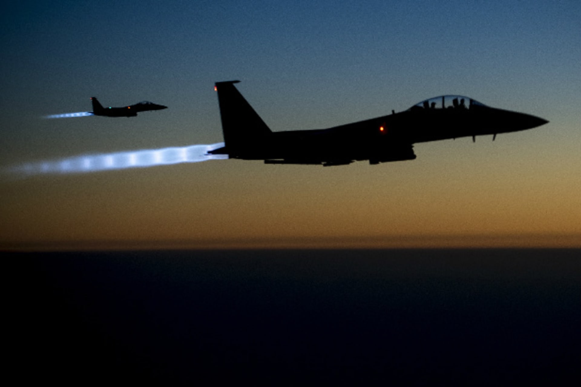 A pair of U.S. Air Force F-15E Strike Eagles fly over northern Iraq after conducting airstrikes in Syria, in this U.S. Air Force handout photo taken early in the morning of September 23, 2014 (Matthew Bruch/Courtesy Reuters).