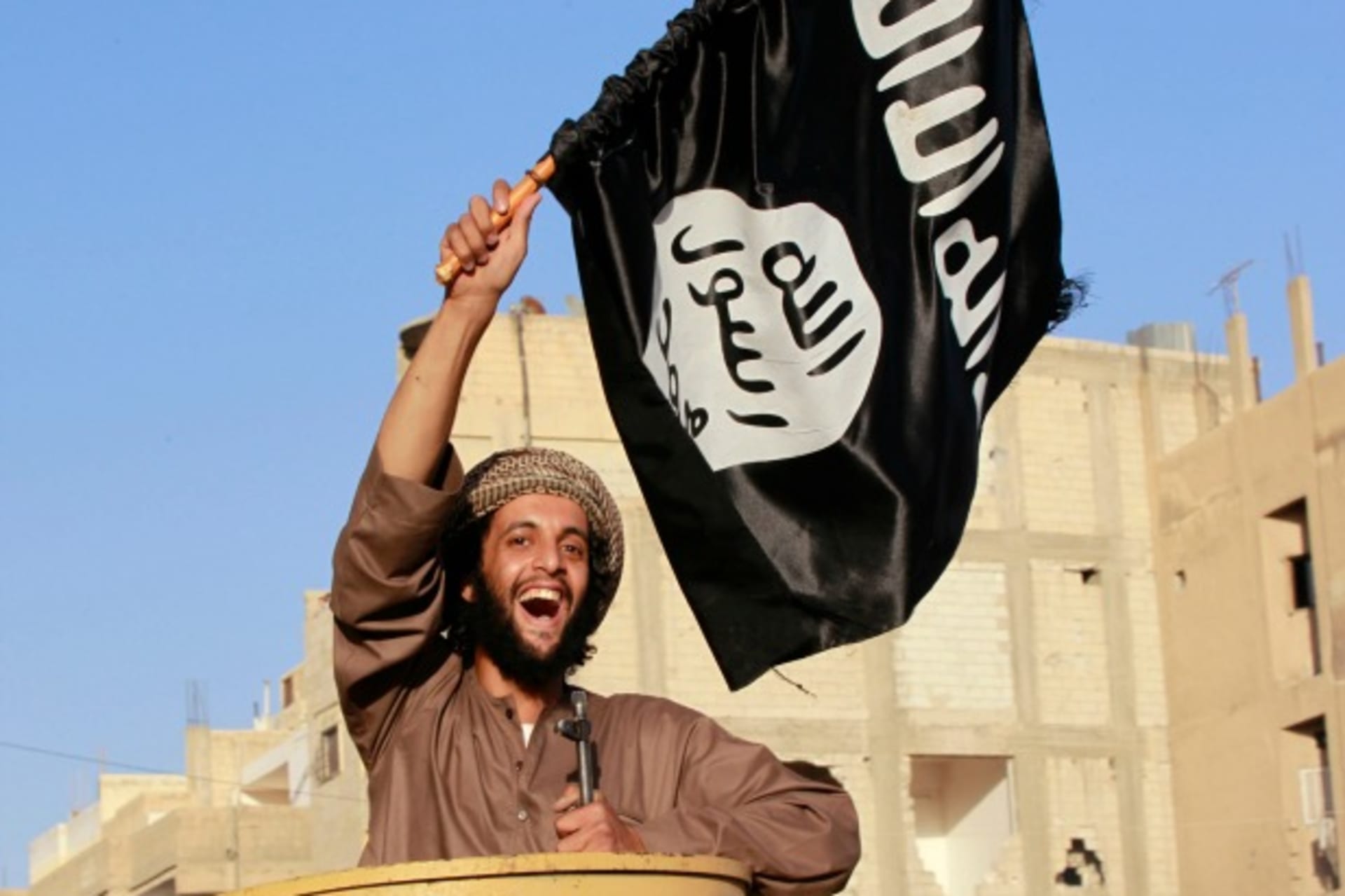 A militant Islamist fighter in Ra’qqa province celebrates the declaration of an Islamic "caliphate" in Iraq and Syria on June 30, 2014. (Stringer/Courtesy Reuters).