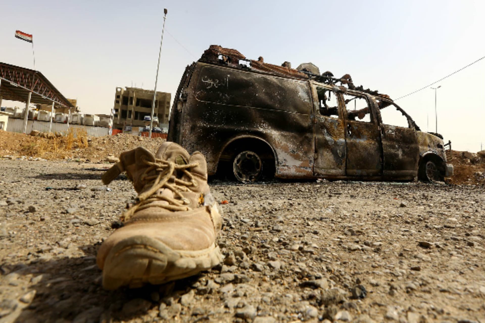 A burnt vehicle belonging to Iraqi security forces is pictured at a checkpoint in east Mosul, one day after radical Sunni Muslim insurgents seized control of the city, June 11, 2014 (Courtesy Reuters).