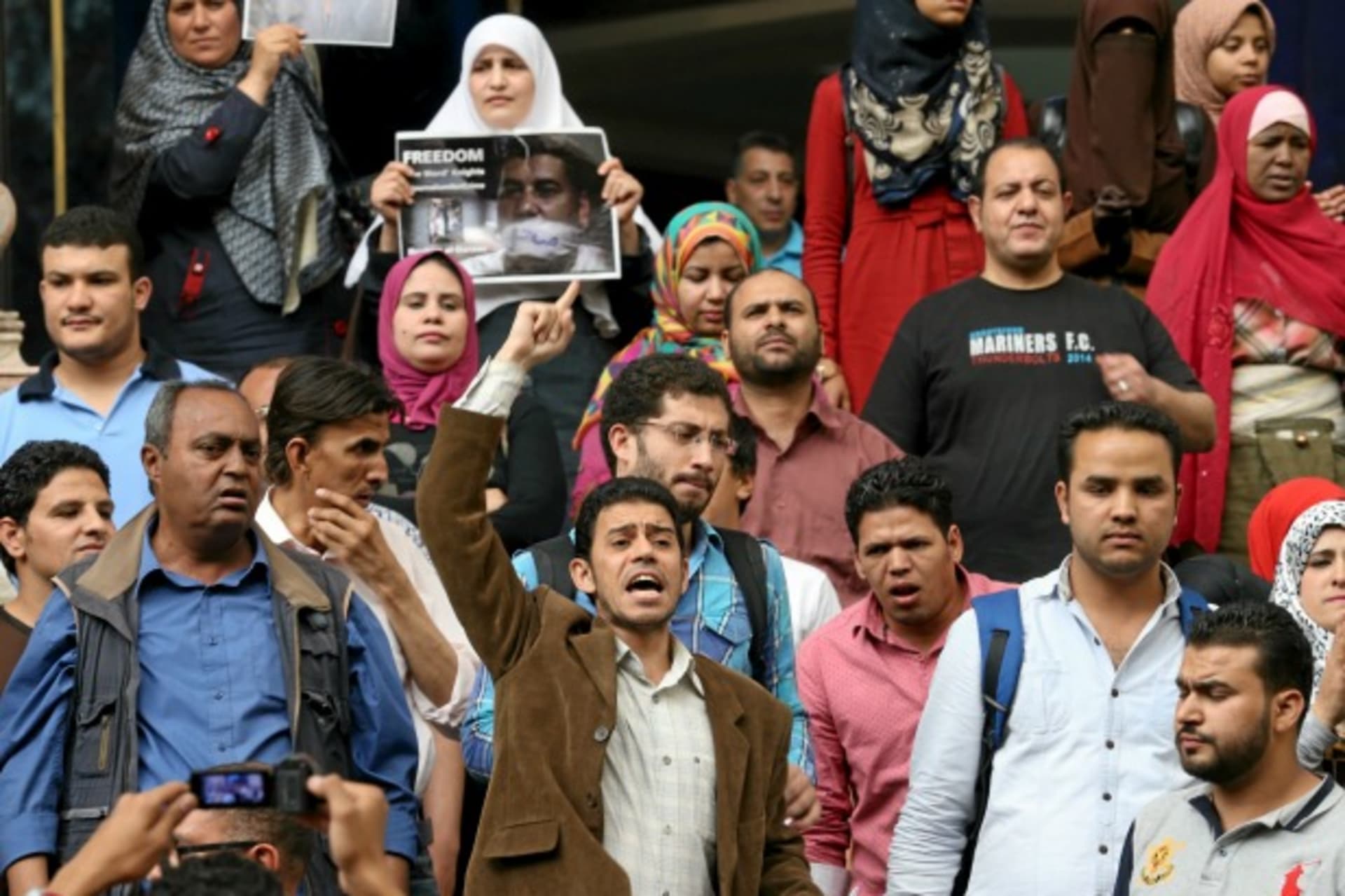 <p>Journalists and activists protest against the restriction of press freedom and to demand the release of detained journalists, in front of the Press Syndicate in Cairo, Egypt (Mohamed Abd El Ghany/Reuters).</p>
