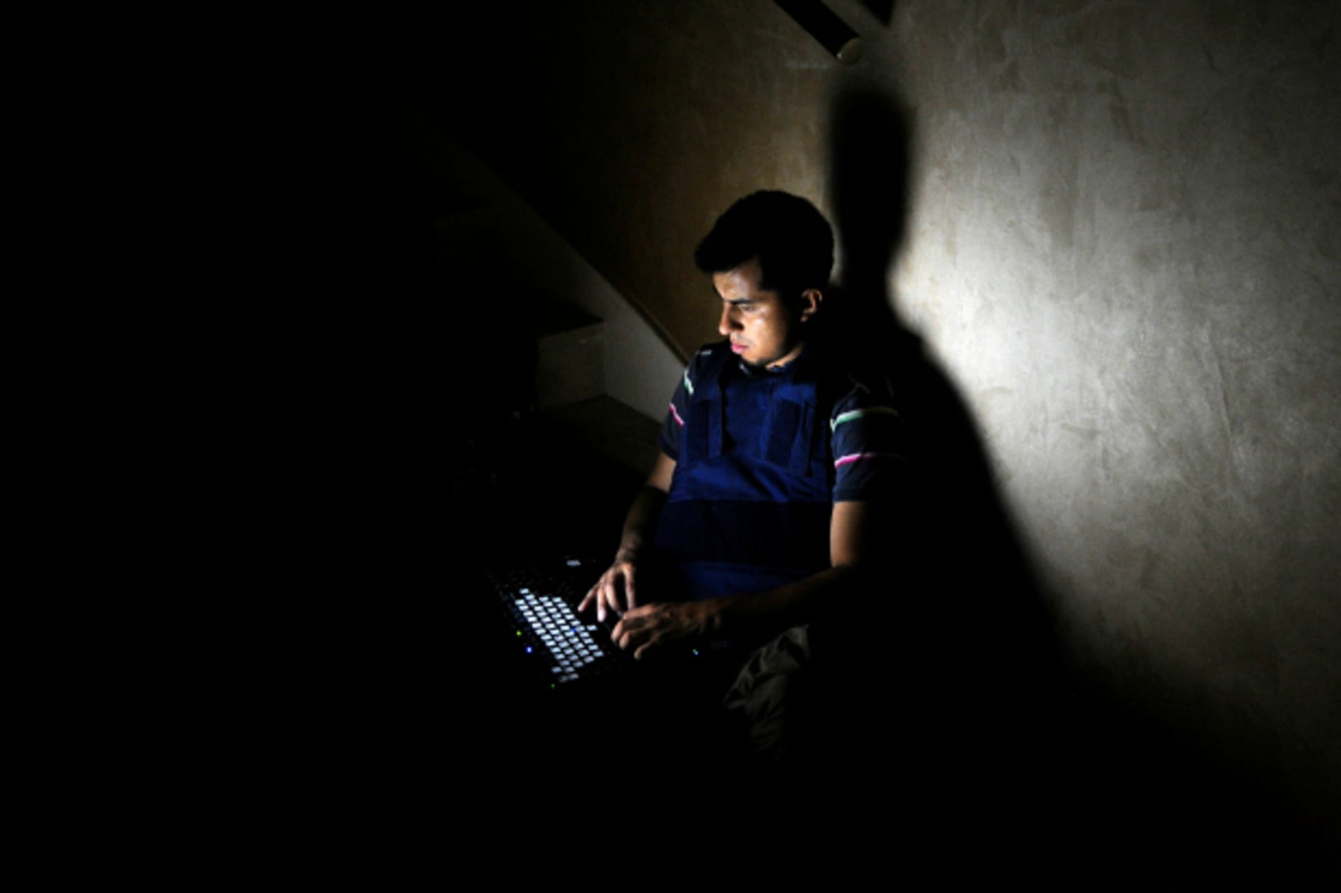 <p>A member of the media works on a staircase at the Rixos hotel during a power cut in Tripoli (Paul Hackett/Reuters).</p>
