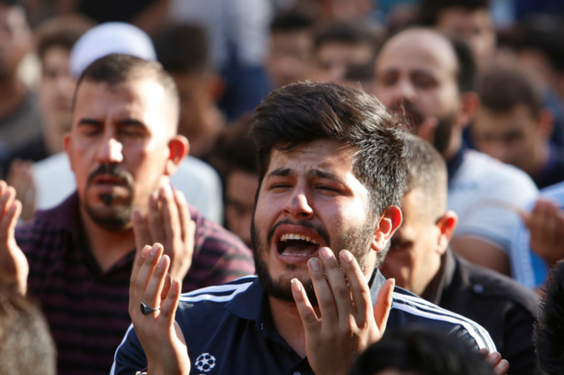 <p>Sunni and Shi’ite Muslims attend prayers during Eid al-Fitr as they mark the end of the fasting month of Ramadan, at the site of a suicide car bomb attack over the weekend at the shopping area of Karrada, in Baghdad, Iraq (Khalid al Mousily/Reuters).</p>