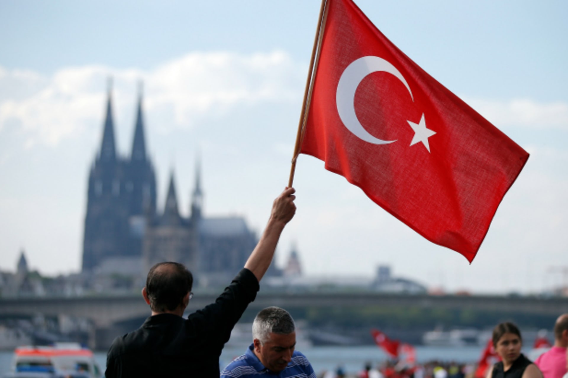 <p>A supporter of Turkish President Tayyip Erdogan waves a Turkish flag during a pro-government protest in Cologne, Germany (Vincent Kessler/Reuters).</p>
