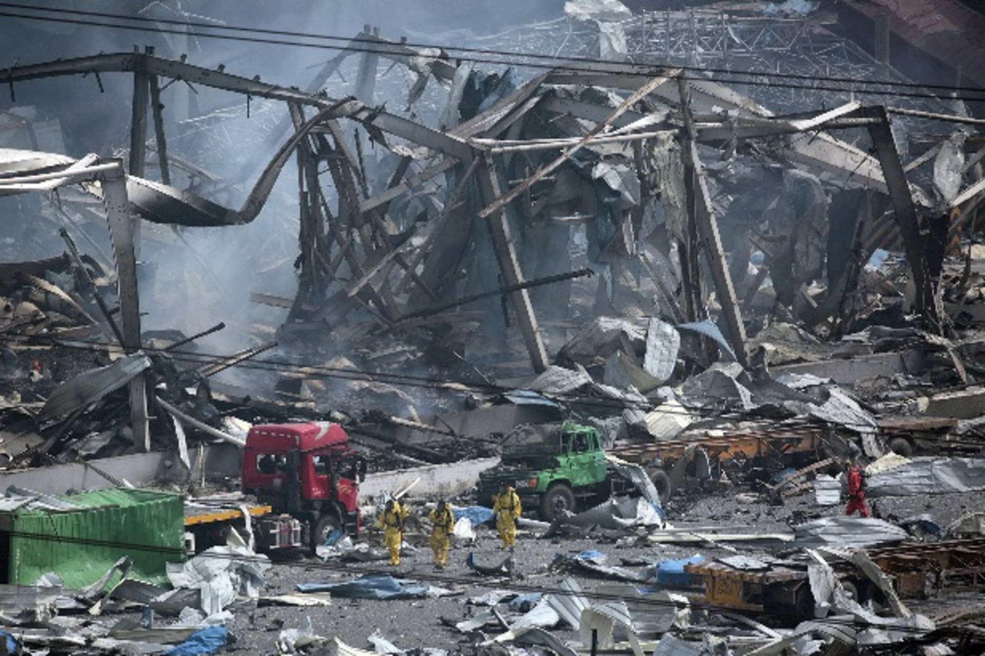 <p>Rescue workers wearing chemical protective suits walk at the site of the explosions at the Binhai new district in Tianjin, Chi… northeast China’s Tianjin that was hit by two massive blasts, a city official told reporters at a briefing. REUTERS/Jason Lee</p>
