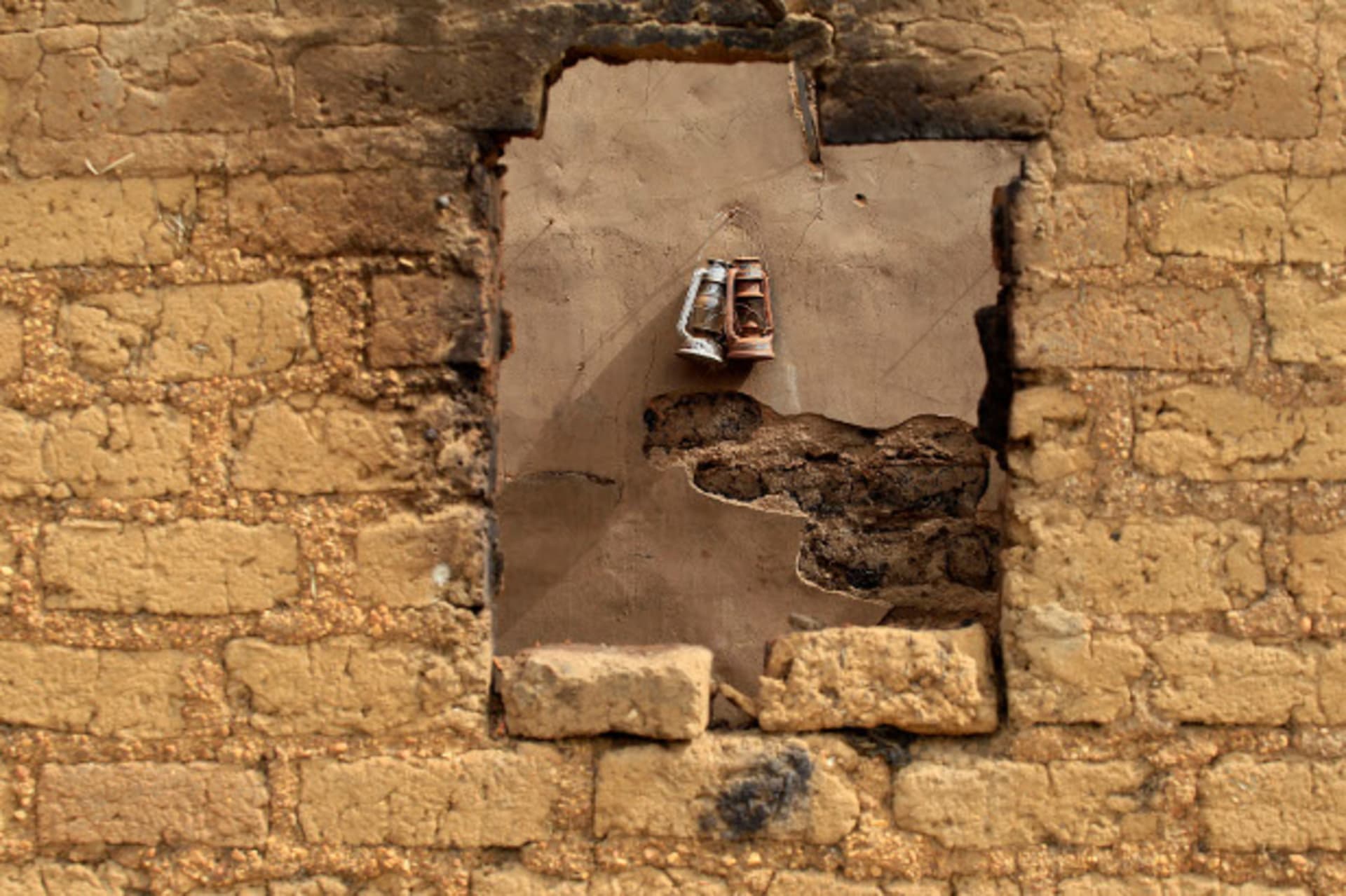 Lanterns hang on the wall in a house where gunmen locked in 42 people and set it on fire, in Angwan Gata, Kaura Local Government Kaduna State March 20, 2014.