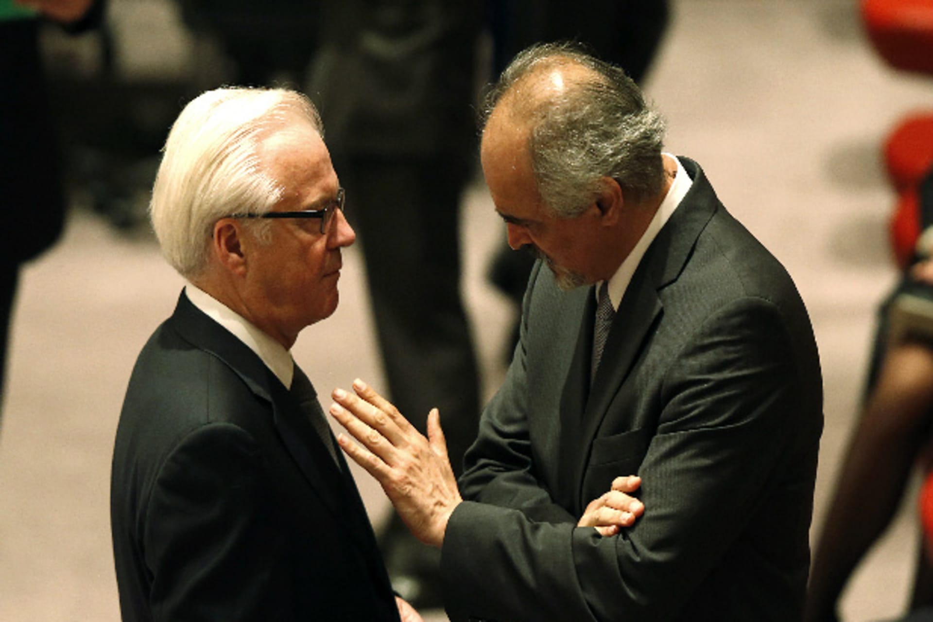 Syria's UN ambassador Bashar Ja'afari (R) talks with Russian ambassador to the United Nations Vitaly Churkin before members of the United Nations Security Council take part in a vote on a resolution eradicating Syria's chemical arsenal during a