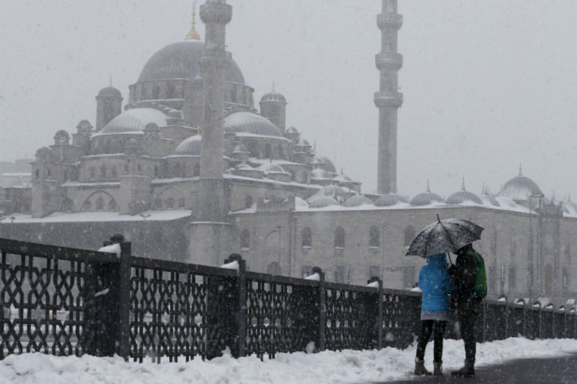 <p>Tourists stroll on the snow-covered Galata bridge in Istanbul, Turkey (Osman Orsal/Reuters).</p>
