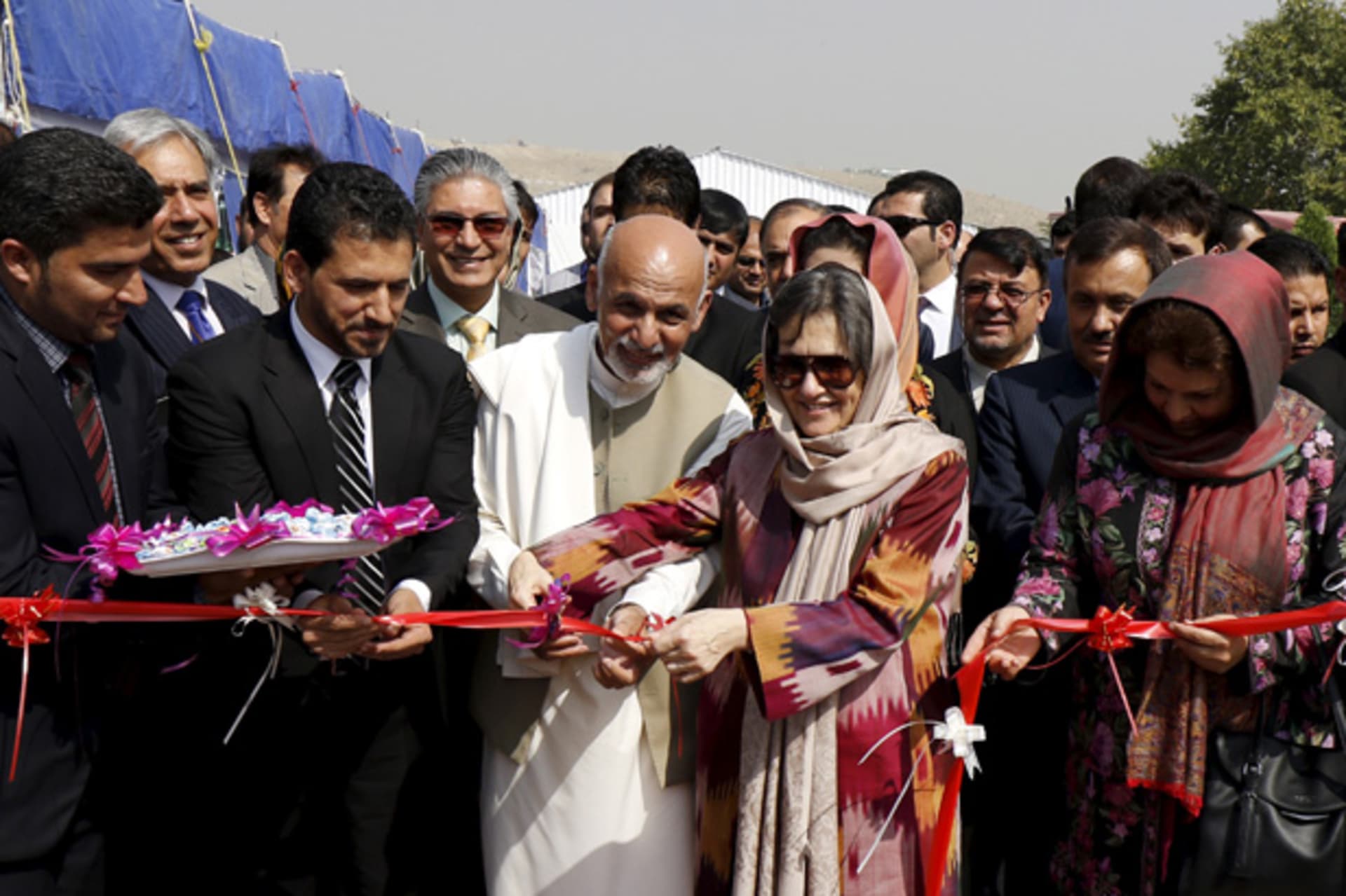 Afghan President Ashraf Ghani cuts a ribbon with his wife Rula Ghani during a ceremony to mark the International Day of Rural Women at Badam Bagh area in Kabul