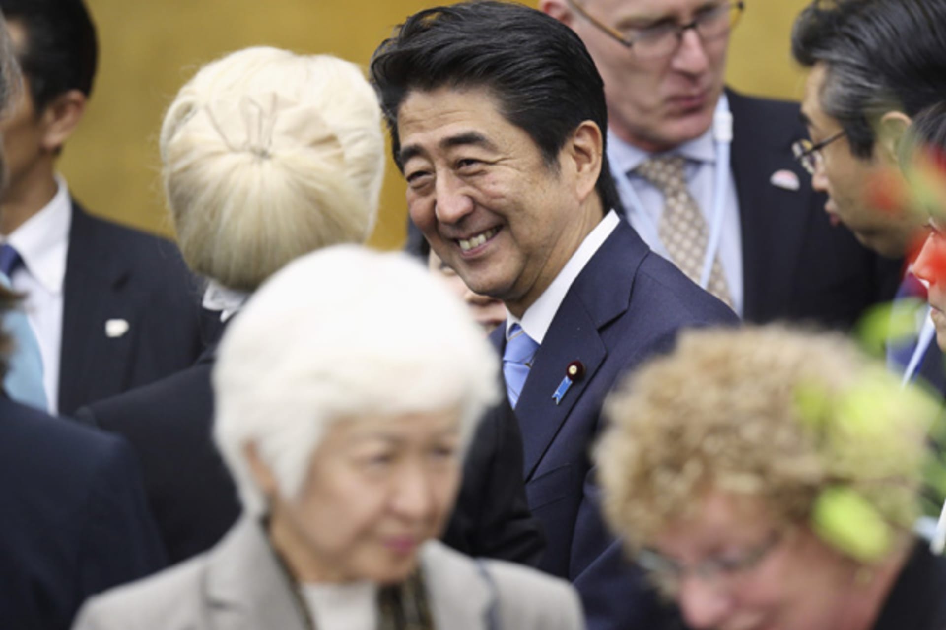 Japan's PM Abe speaks to an attendee during the reception for the World Assembly for Women in Tokyo