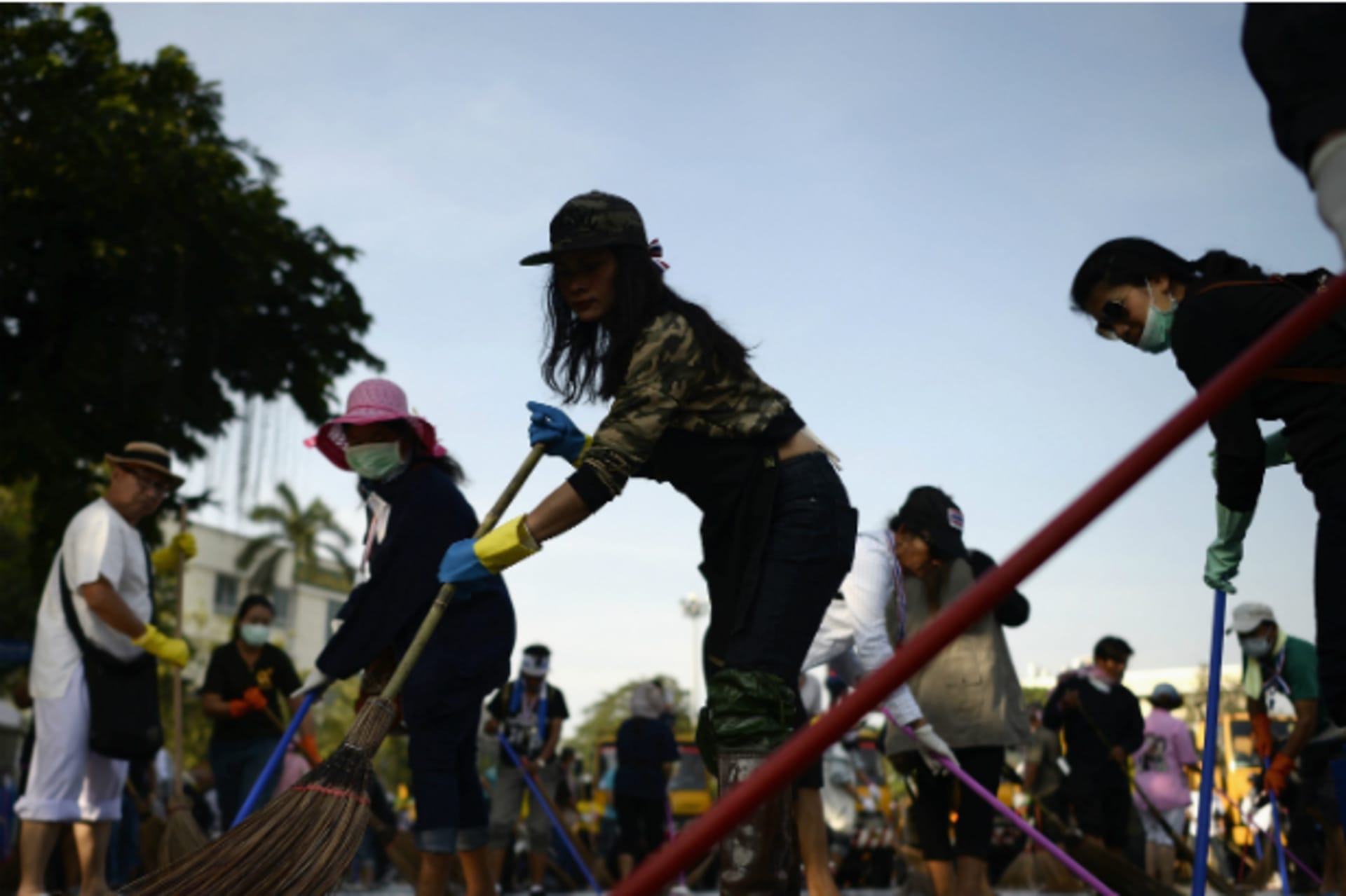 <p>Anti-government protesters sweep the street around the Democracy Monument after weeks of protesting and days of clashes with police in Bangkok’s city centre on December 4, 2013. (Dylan Martinez/Courtesy Reuters)</p>

