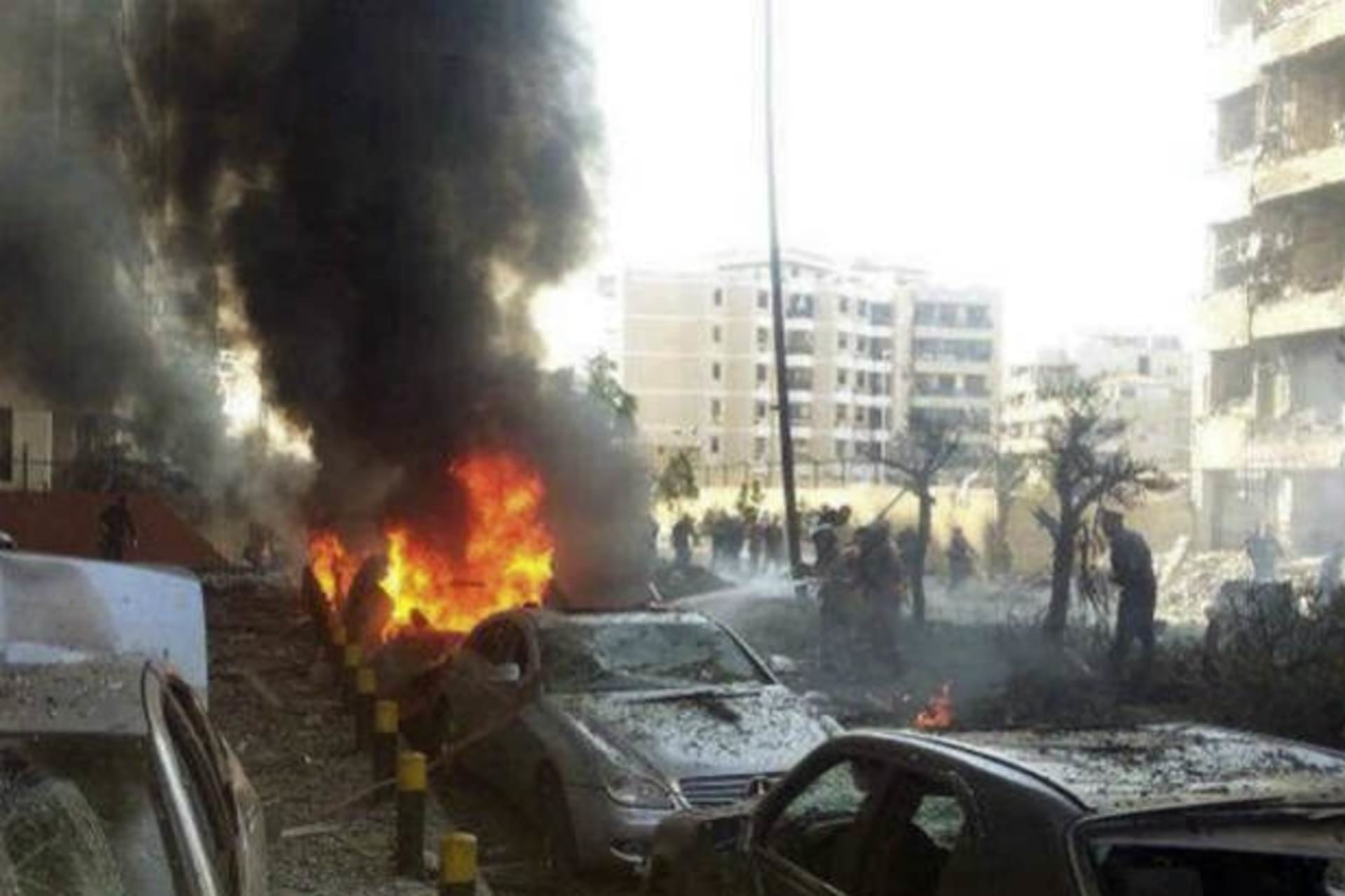 <p>Civil Defence personnel extinguish a fire on cars at the site of the explosions near the Iranian embassy in Beirut November 19, 2013 (Yassine/Courtesy Reuters).</p>
