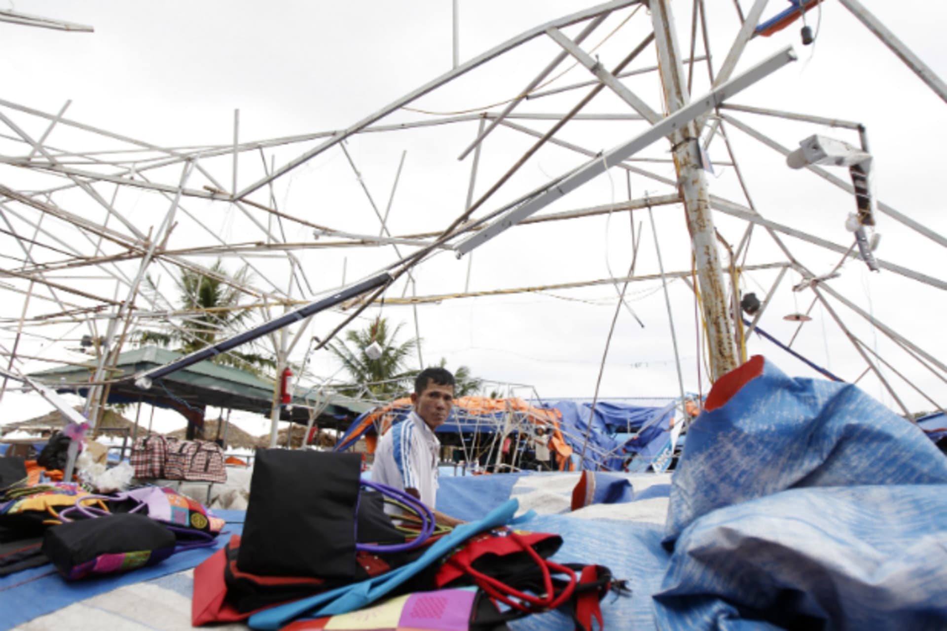 <p>A man sits at his damaged shop in the aftermath of typhoon Haiyan in Vietnam’s northern Quang Ninh province, 180 km (112 miles) from Hanoi on November 11, 2013. (Nguyen Huy Kham/Courtesy Reuters)</p>

