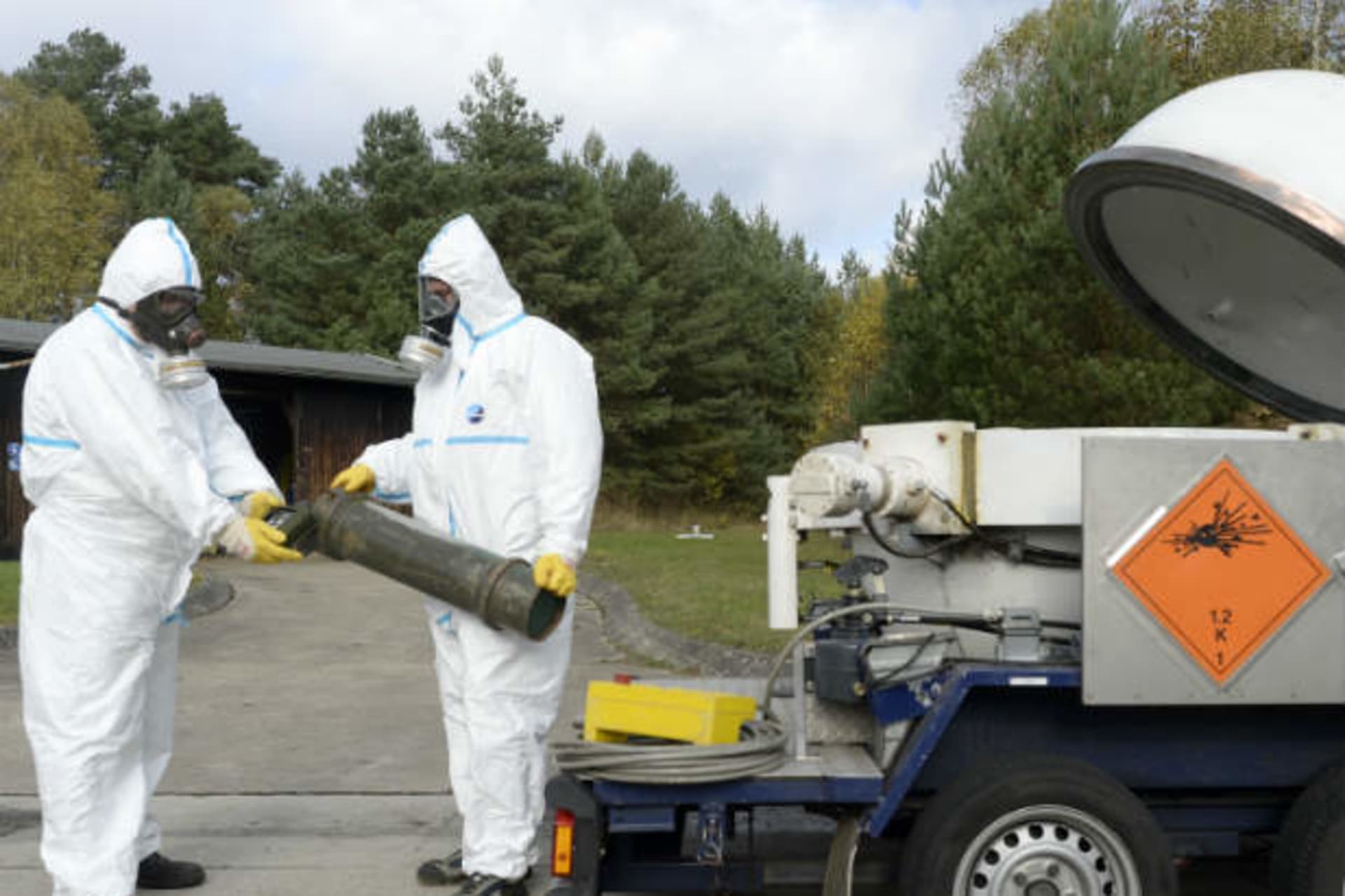 Workers dressed in protective clothes during a chemical weapons demonstration (Bimmer/Courtesy Reuters).