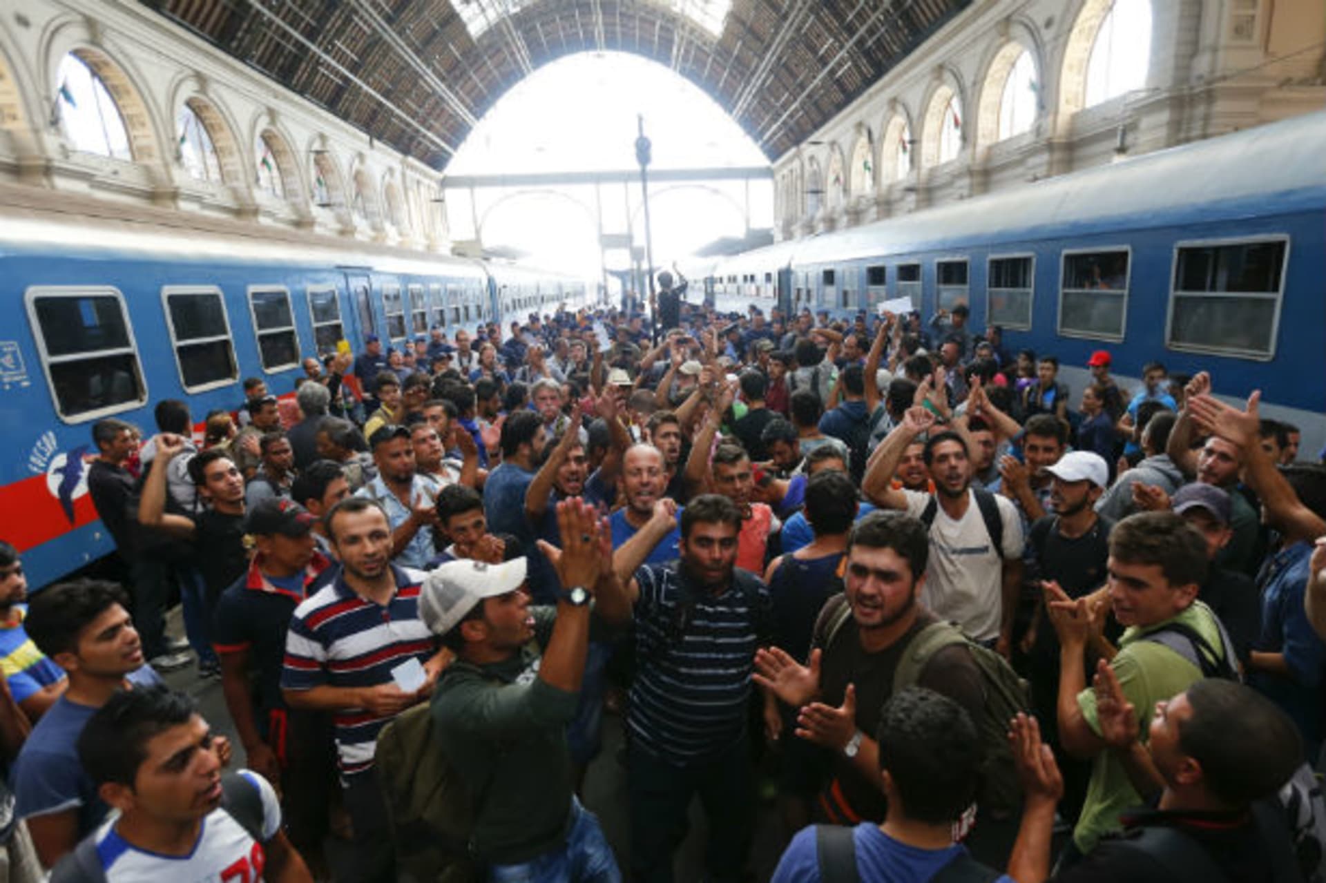 <p>Migrants gesture as they stand in the main Eastern Railway station in Budapest, Hungary, on September 1, 2015.</p>
