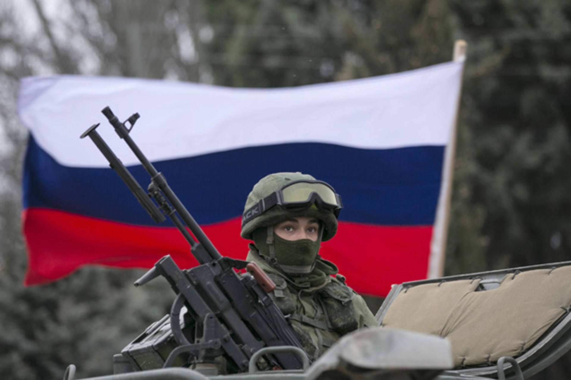 <p>A soldier posted in the Crimean town of Balaclava is seen in front of a Russian flag. (Baz Ratner/ Courtesy Reuters)</p>
