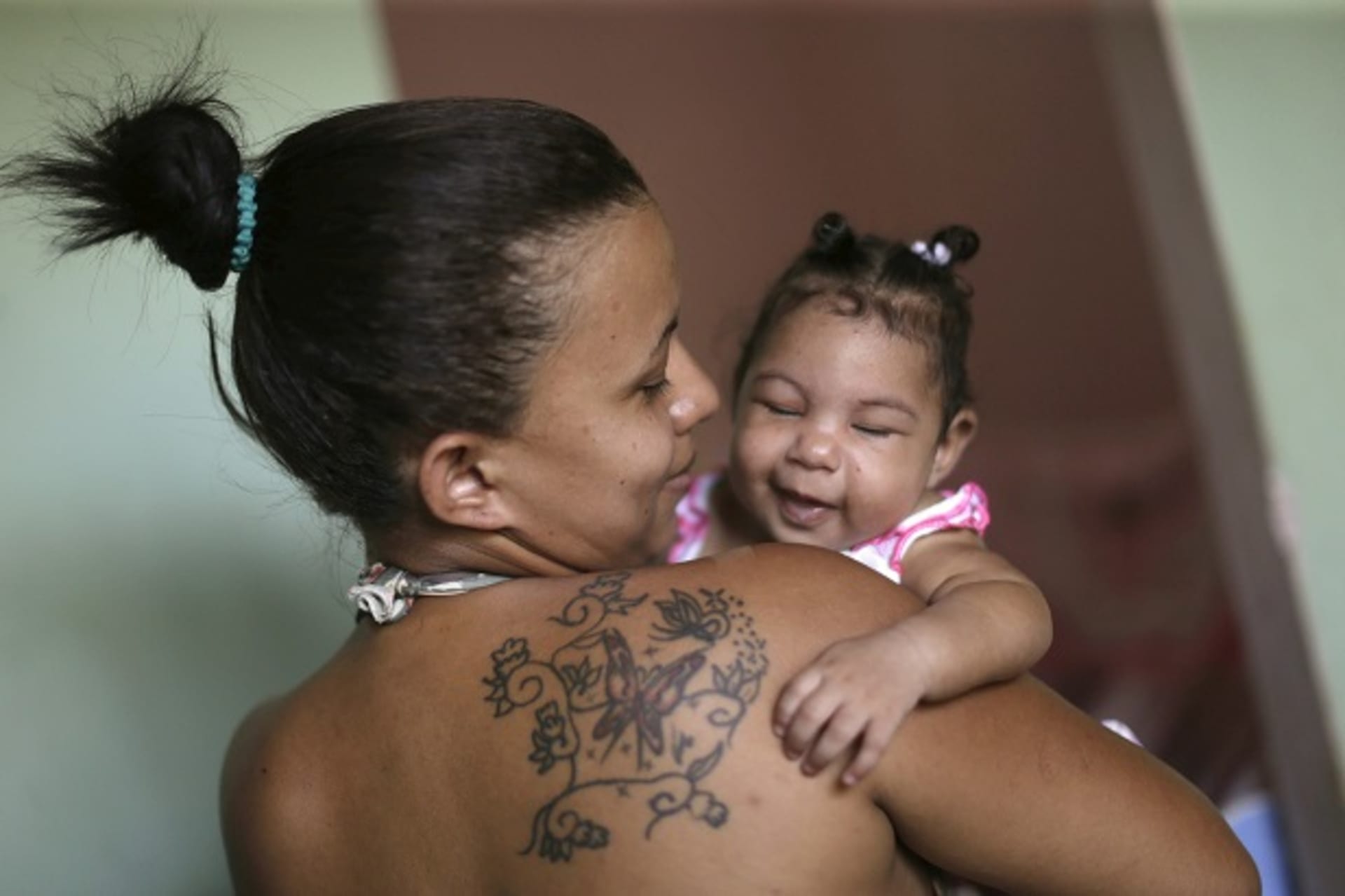 Rosana Vieira Alves holds her 4-month-old daughter Luana Vieira, who was born with microcephaly, pictured here at their house on February 3, 2016 in Brazil, which is investigating more than 4,000 suspected cases of this birth disorder, which ma