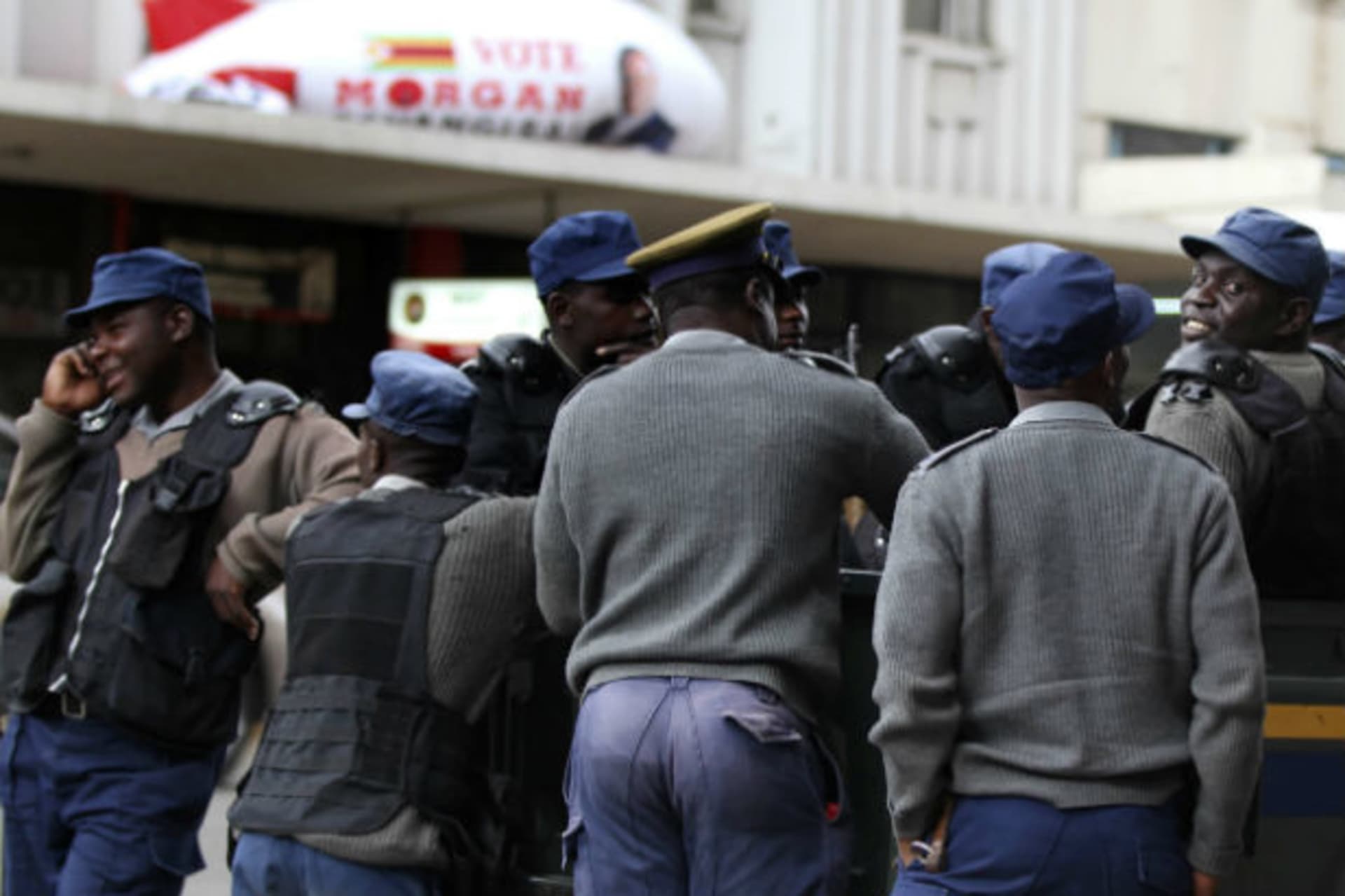 Zimbabwean police stand outside the opposition party Movement For Democratic Change (MDC) head offices in Harare August 1, 2013.