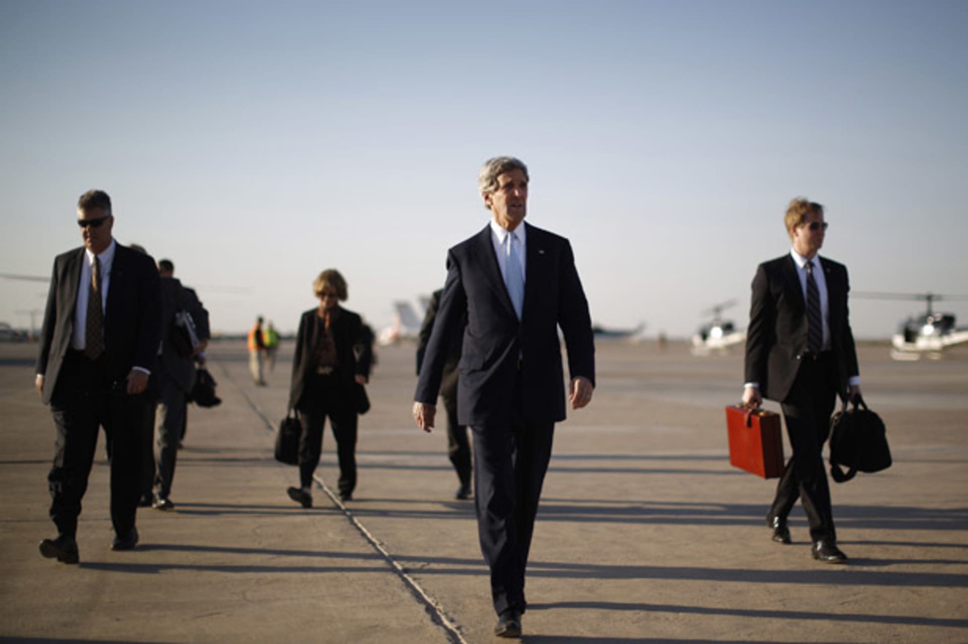 <p>Secretary of State John Kerry walks across the tarmac of Baghdad International Airport on a March visit to Iraq (Jason Reed/Courtesy Reuters).</p>
