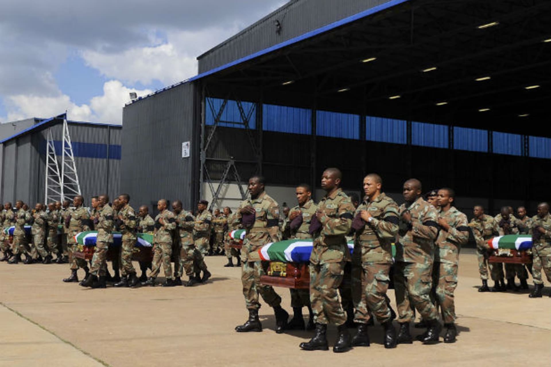 Members of the South Africa National Defence Force (SANDF) carry the mortal remains of 13 members that were killed in Central African Republic (CAR) during the handing over to the respective families at the Waterkloof Air Force Base, in Pretori