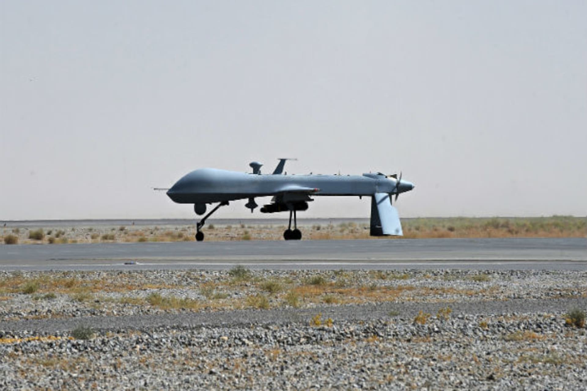 <p>A U.S. Predator unmanned drone armed with a missile stands on the tarmac of Kandahar military airport. (Massoud Hossaini/Courtesy Reuters).</p>
