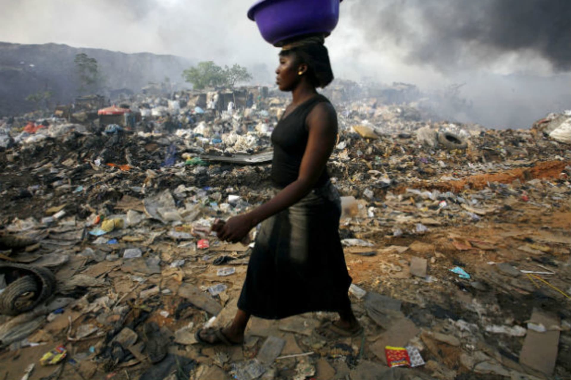 Lagos, Nigeria A woman walks through Olusosun rubbish dump in Nigeria's commercial capital Lagos April 18, 2007.