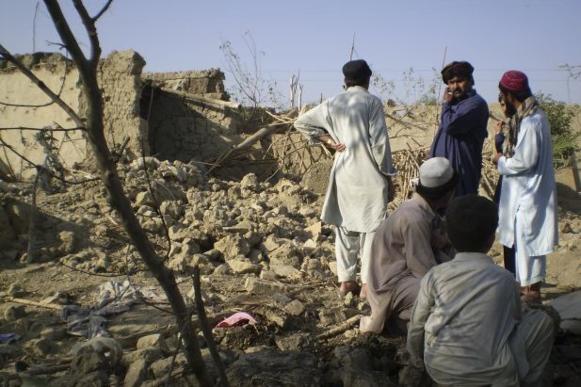 <p>Tribesmen gather at a site of a suspected drone strike on the outskirts of Miranshah, Pakistan, near the Afghan border in October 2008 (Haji Mujtaba/Courtesy Reuters).</p>
