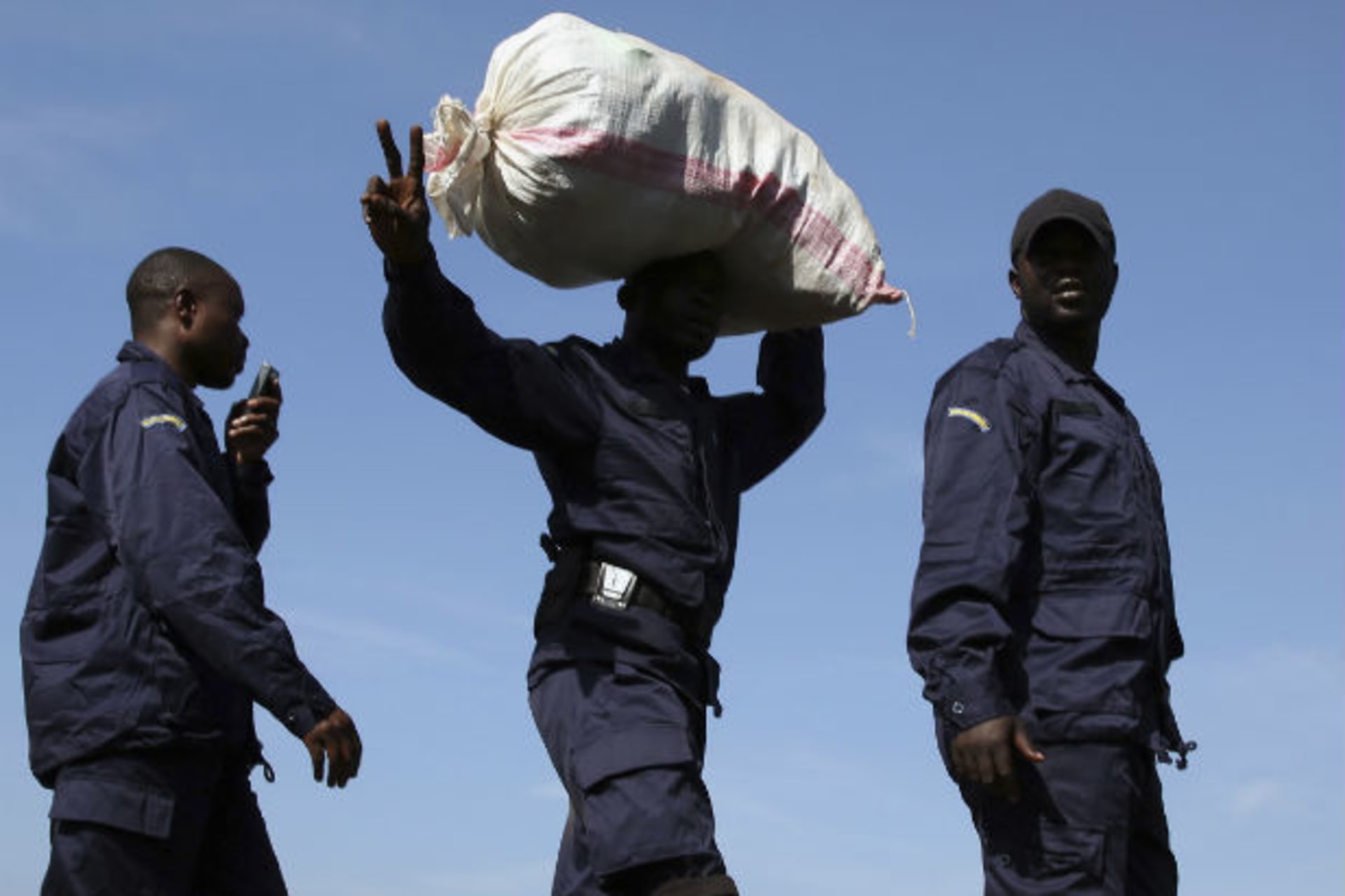 A newly deployed police officer gestures as he walks in a line in Goma port December 2, 2012.