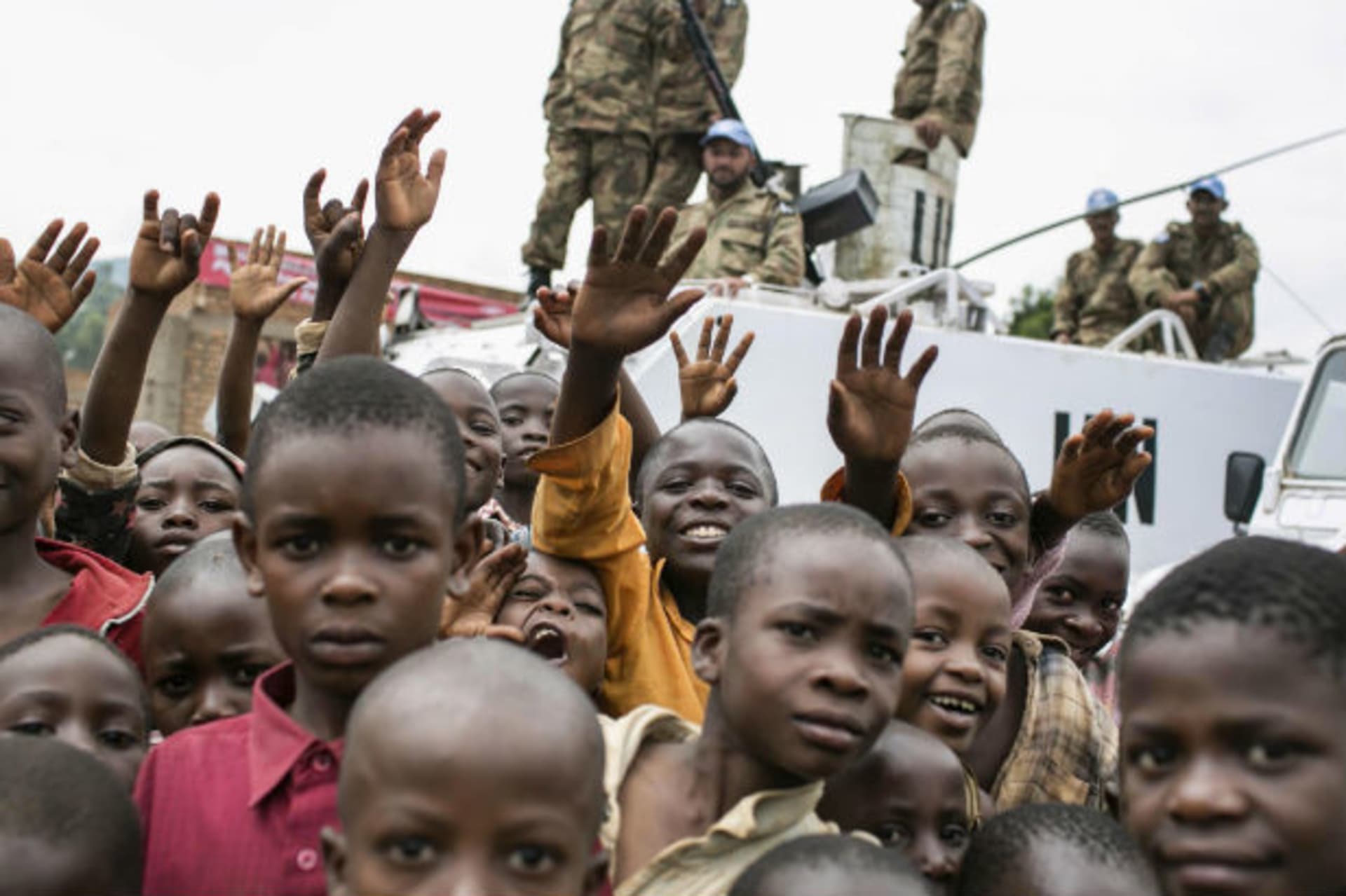 Congolese children gather in front of a United Nations peacekeeping tank during the global rally "One Billion Rising" which is part of a V-Day event calling for an end to gender-based violence, in Bukavu February 14, 2013.
