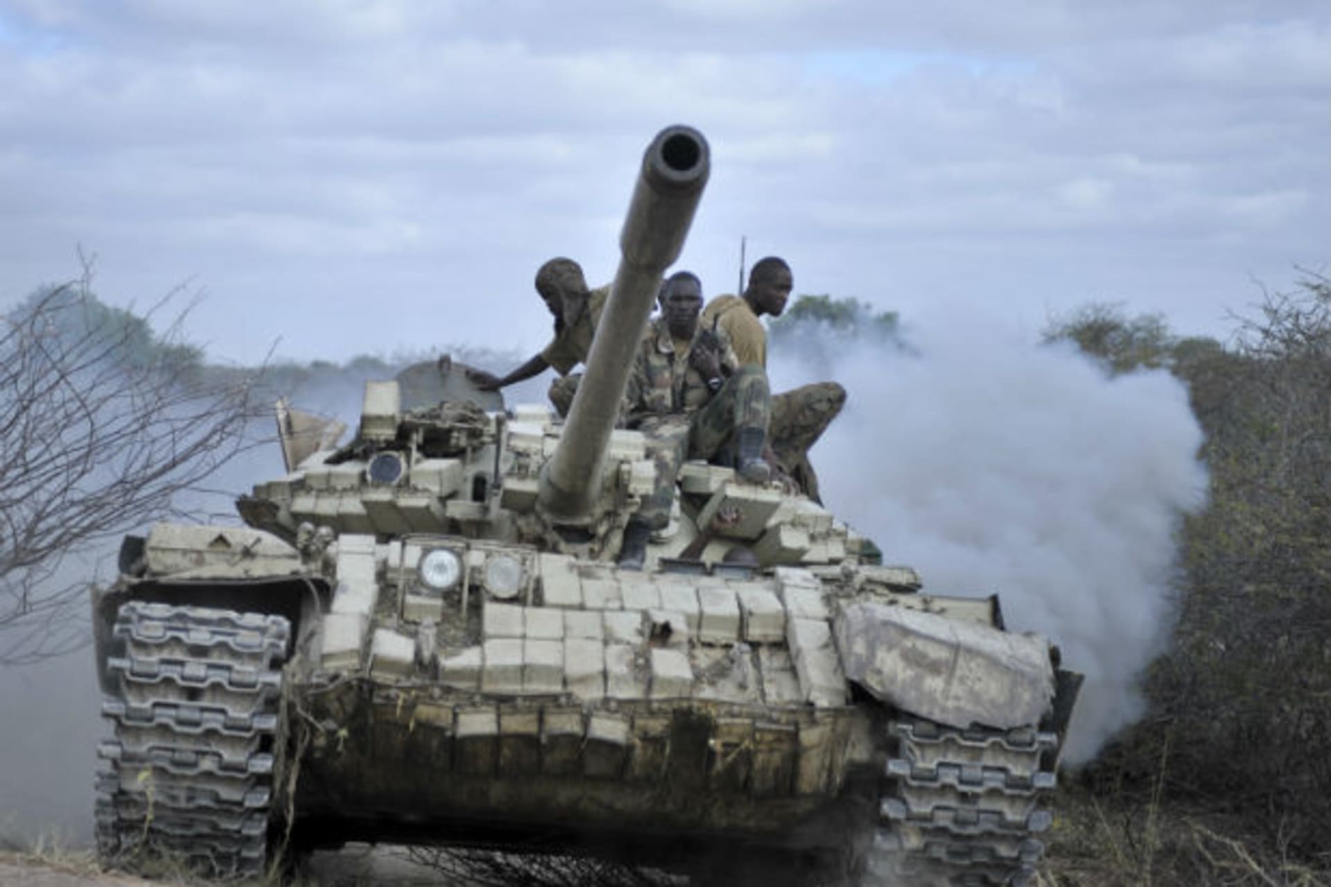 Ugandan soldiers, operating under the African Union Mission in Somalia (AMISOM), sit on a tank as they advance towards Buurhakaba from their former position in the town of Leego, alongside members of the Somali National Army (SNA) on February 2