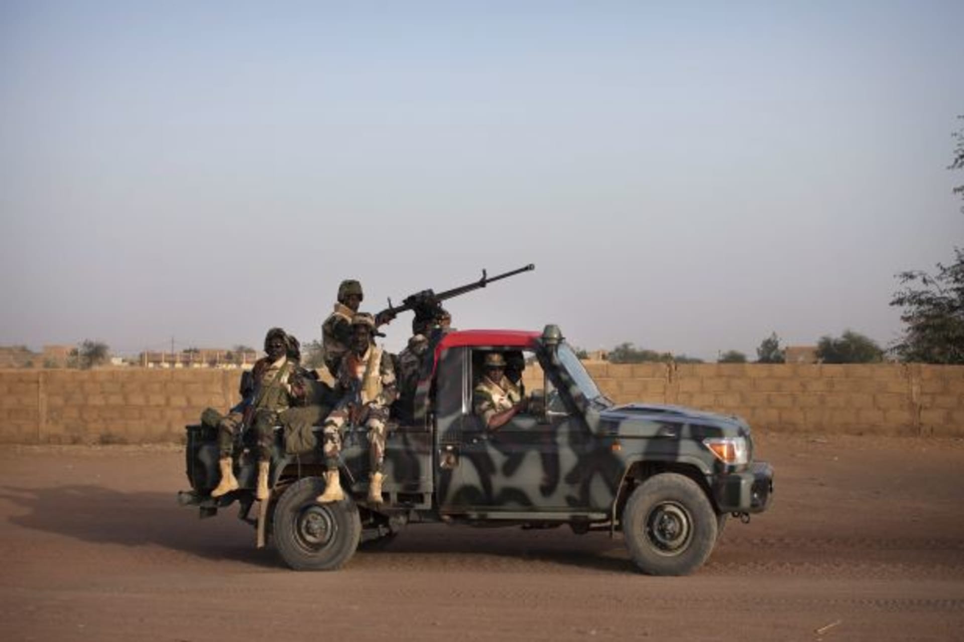 <p>Malian soldiers patrol the streets of Gao on February 20, 2013 (Joe Penney/Courtesy Reuters).</p>
