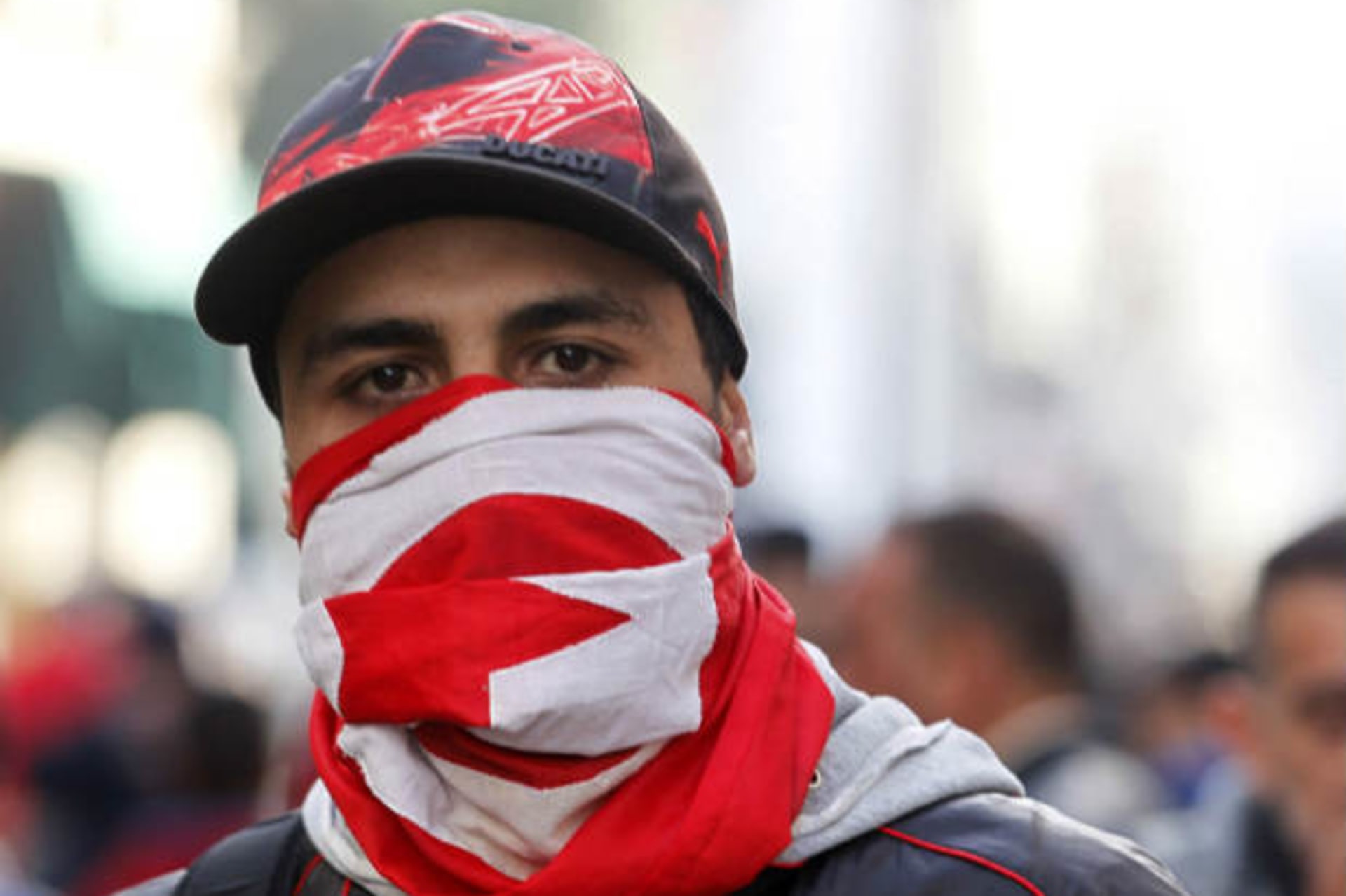 A protester wears a Tunisian flag during a demonstration in Tunis February 7, 2013 (Larbi/Courtesy Reuters).