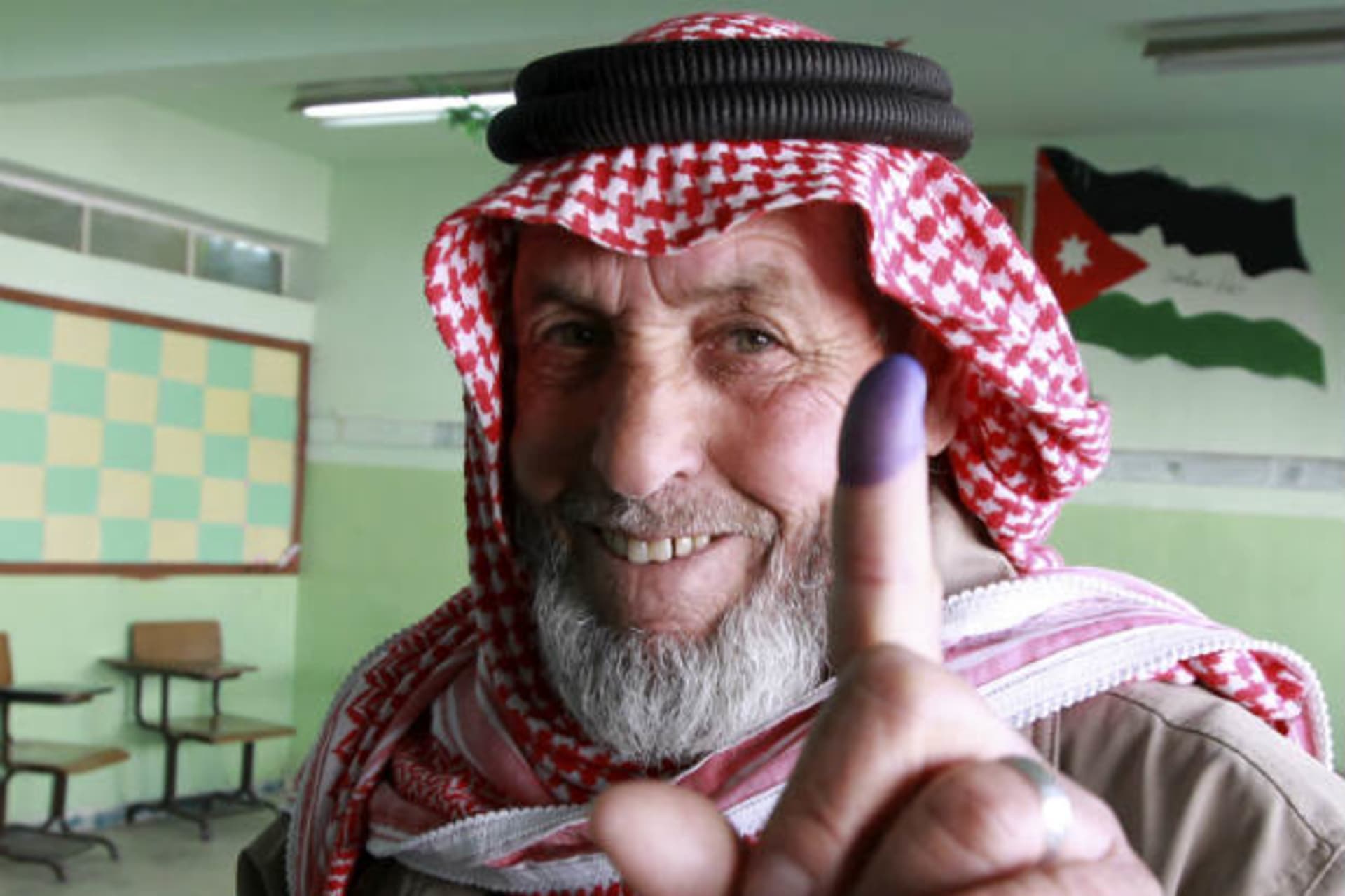 A man shows his ink-stained finger after voting at a polling station in Amman on January 23, 2013 (Hammad/Courtesy Reuters).