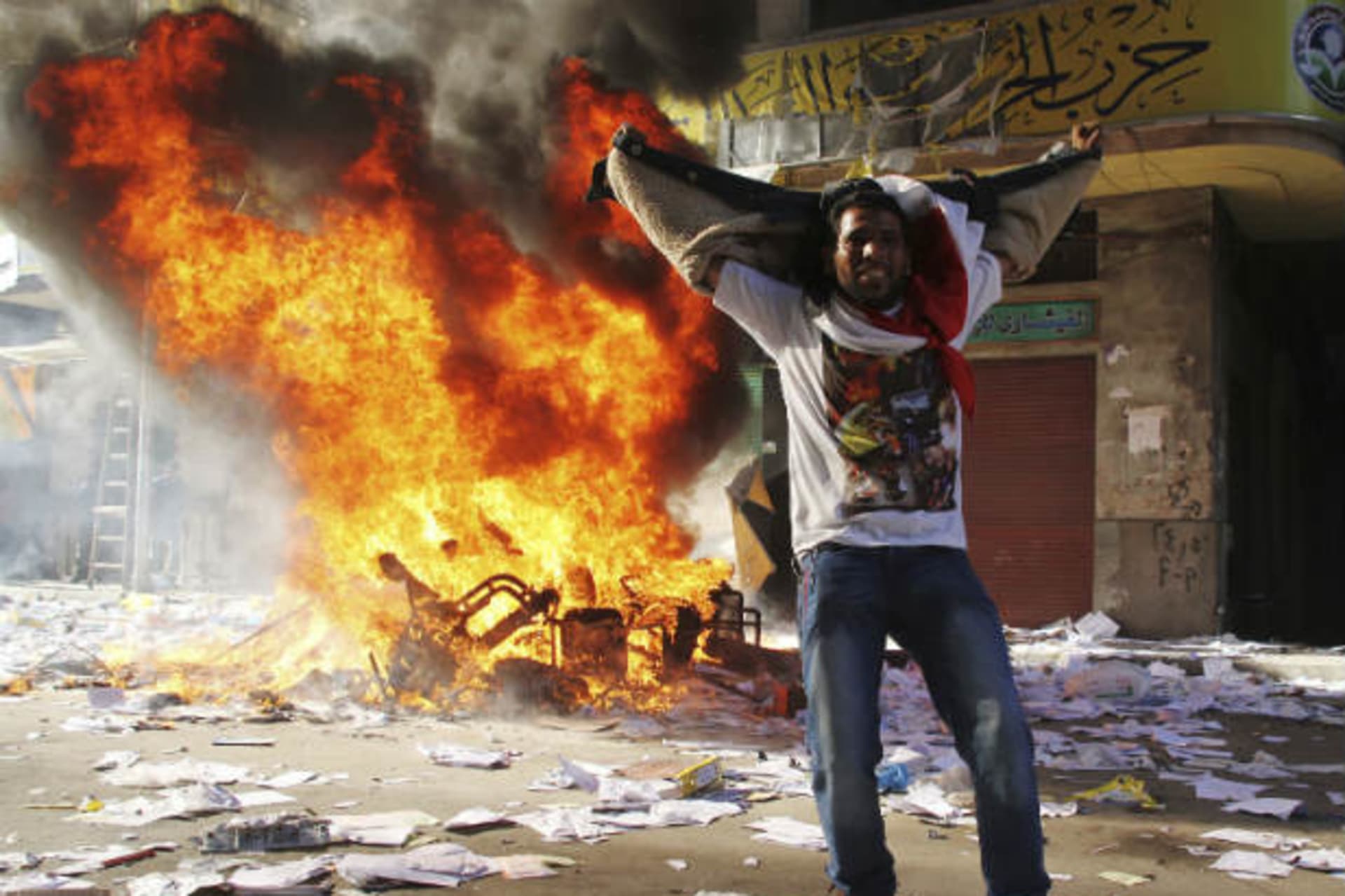 A protester cheers as items ransacked from an office of the Muslim Brotherhood's Freedom and Justice Party burn in Alexandria on November 23, 2012 (Stringer/Courtesy Reuters).