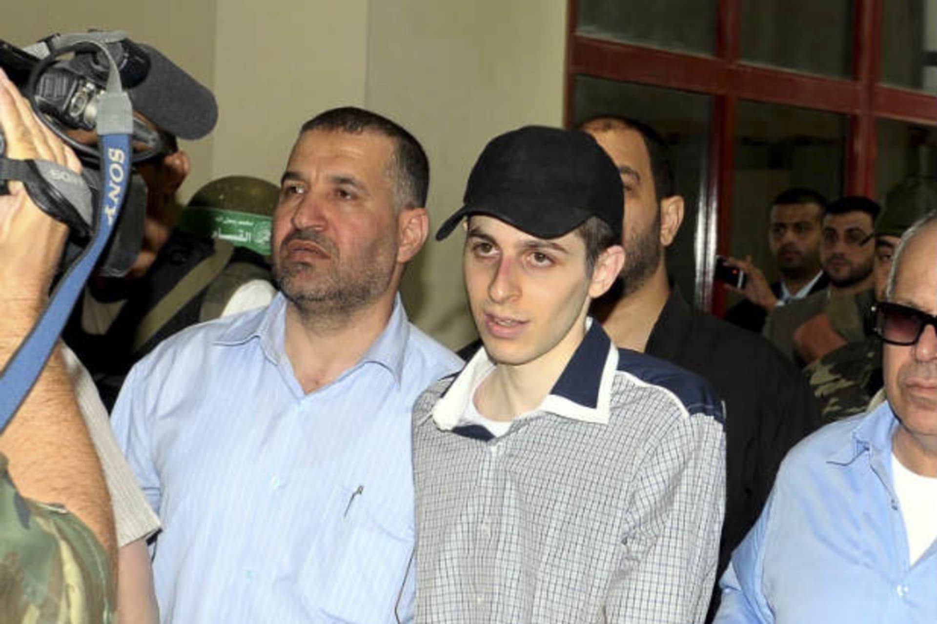 Ahmed Al-Jaabari, chief of the armed wing of Hamas, escorting Israeli soldier Gilad Shalit on the Egyptian side of the Rafah border crossing on October 18, 2011 (Farid/Courtesy Reuters).