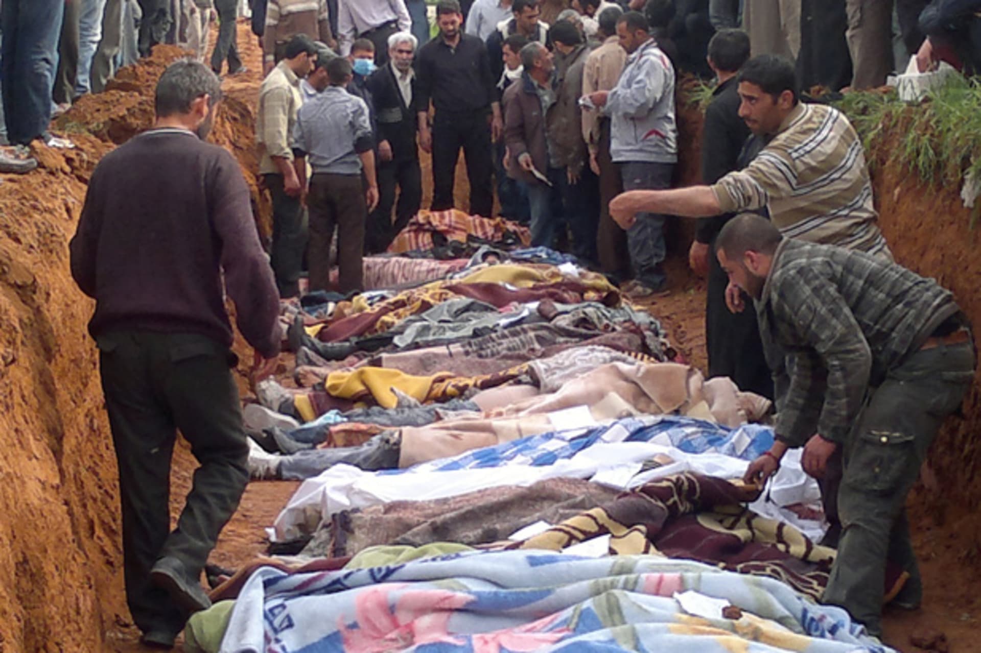 People carry the body of men, whom activists say were killed by the Syrian government army, in Taftanaz village, east of Idlib city April 5, 2012. Picture taken April 5, 2012. (Shaam News/Courtesy Reuters)