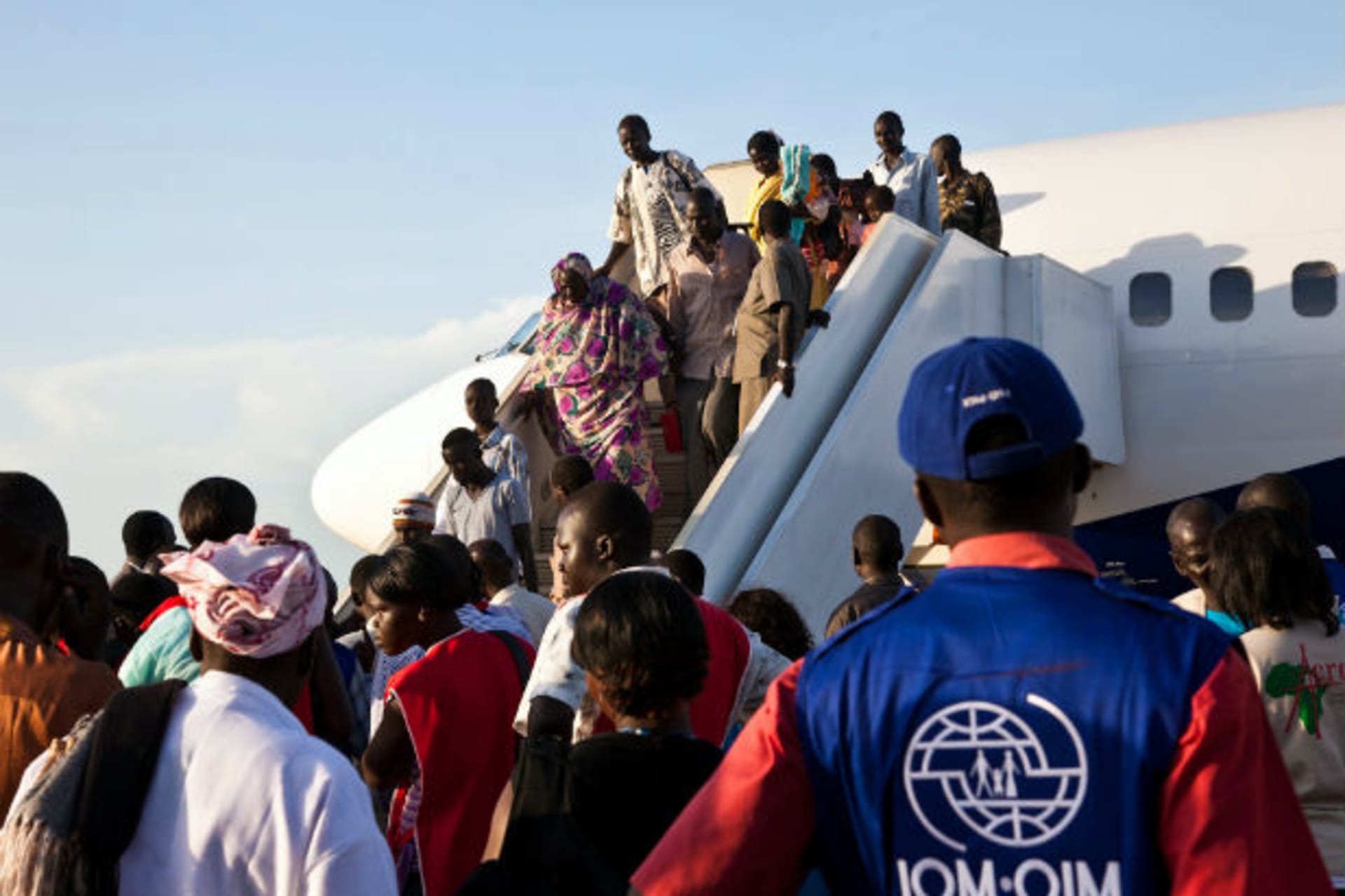 South Sudanese returnees from Khartoum disembark from a plane as they arrive in South Sudan's capital Juba