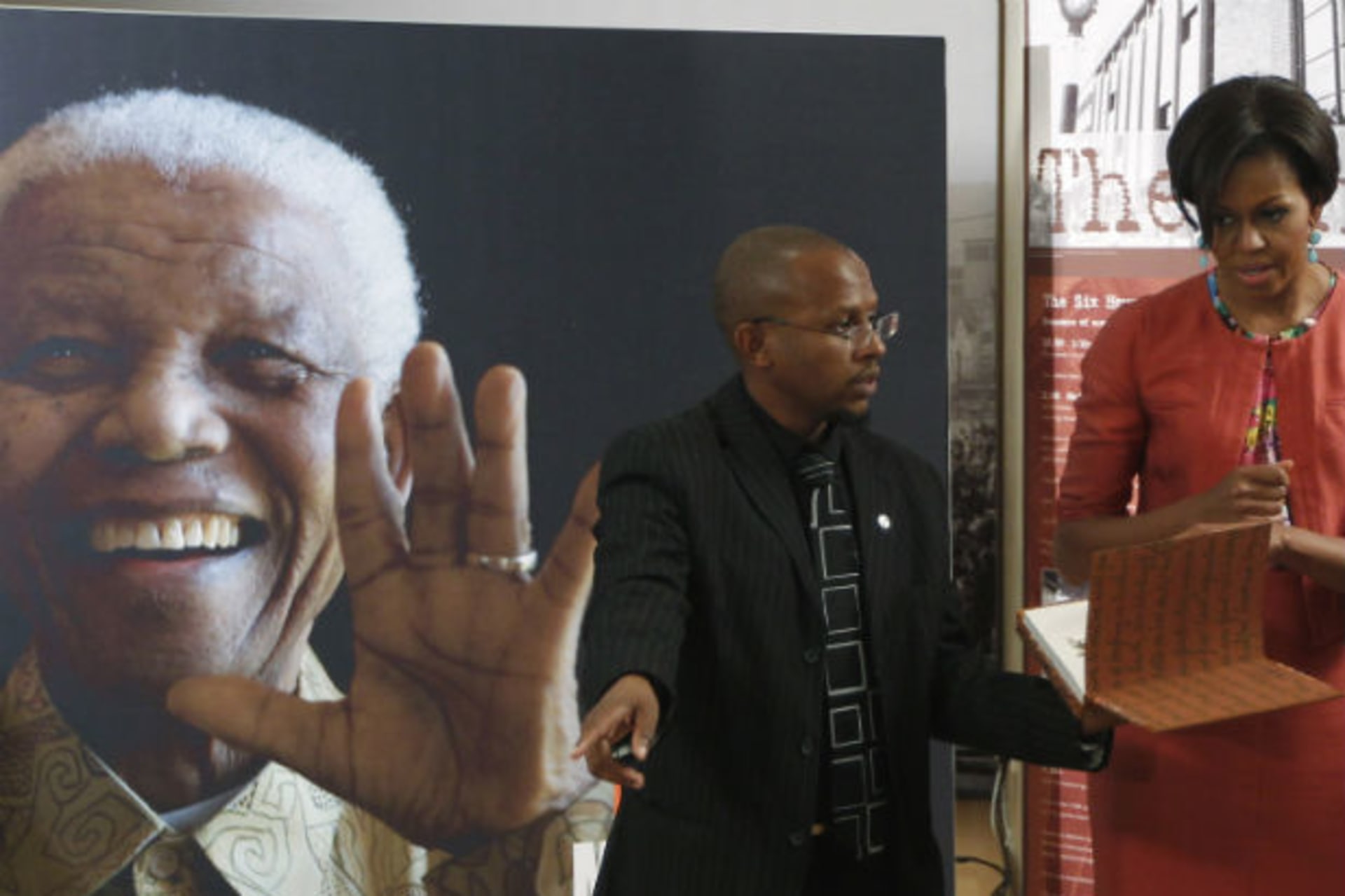U.S. first lady Michelle Obama stands with Sello Hatang of the Nelson Mandela Foundation during her visit in Johannesburg June 21, 2011.
