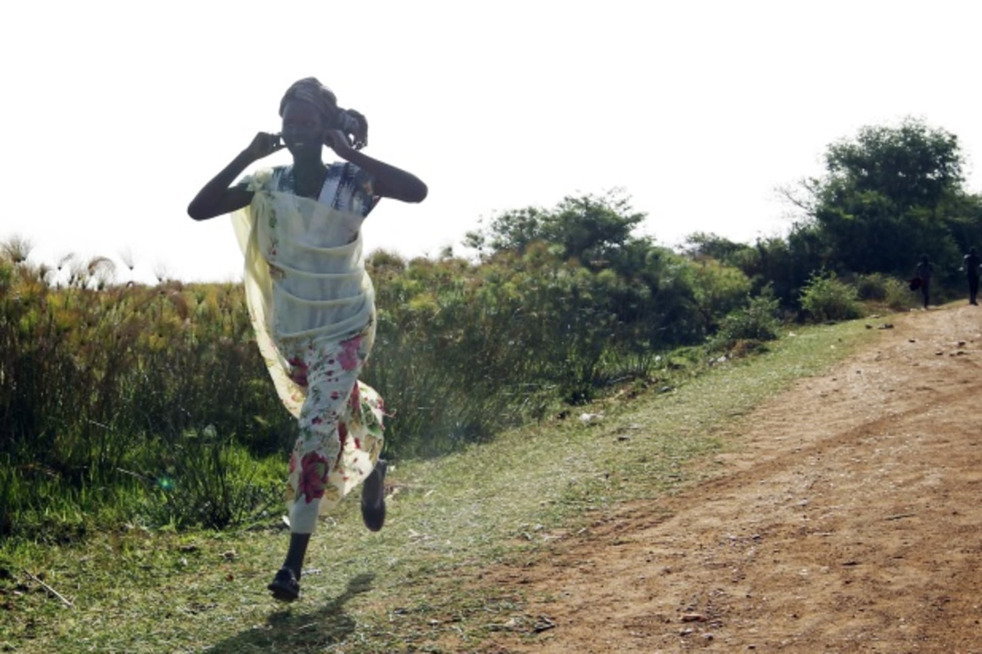 <p>A woman runs from an air strike by the Sudanese air force in Rubkona, South Sudan (Courtesy Reuters/Goran Tomasevic).</p>
