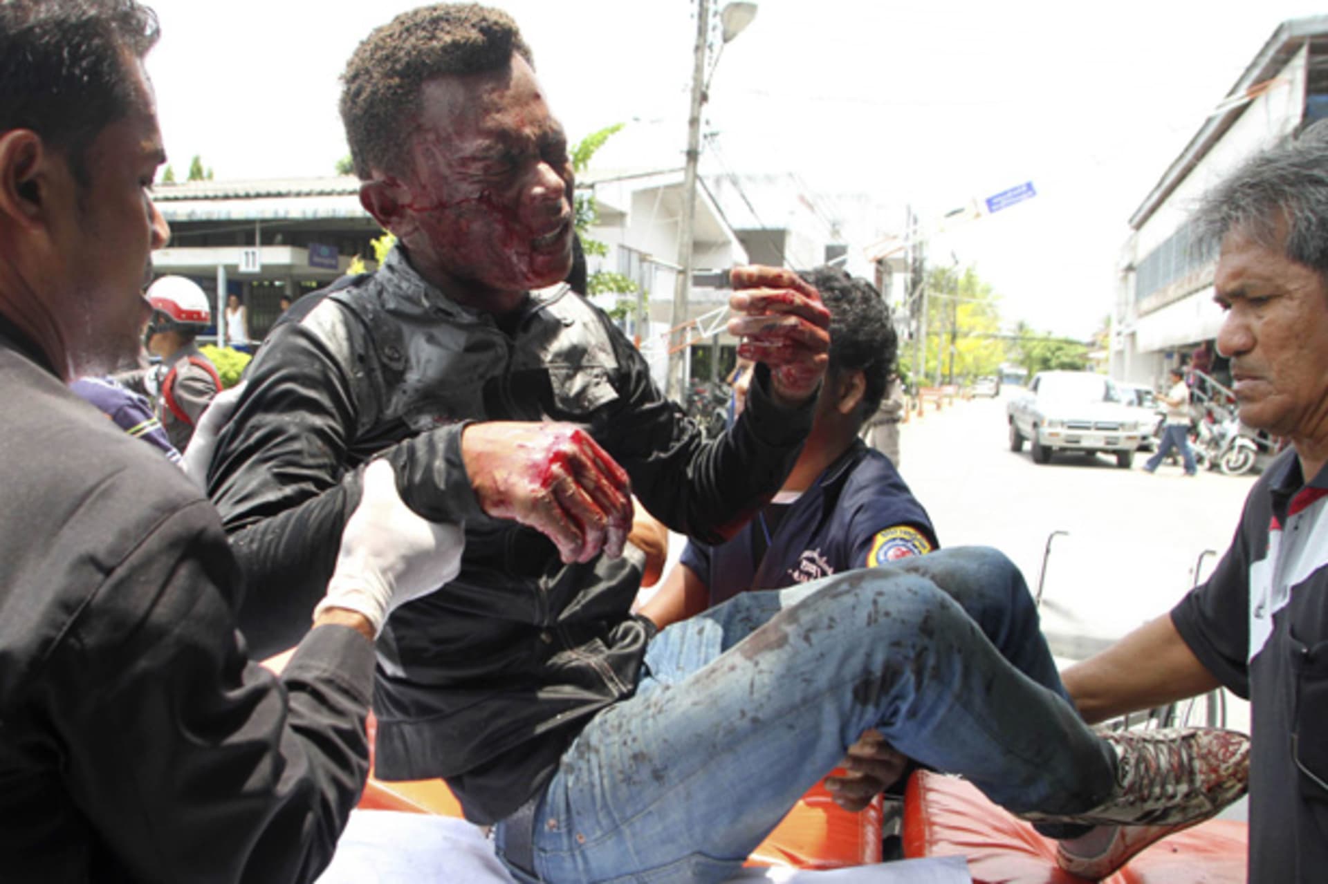 <p>Thai rescue workers help an injured man after a bomb blast in southern Thailand’s Yala province March 31, 2012.</p>

