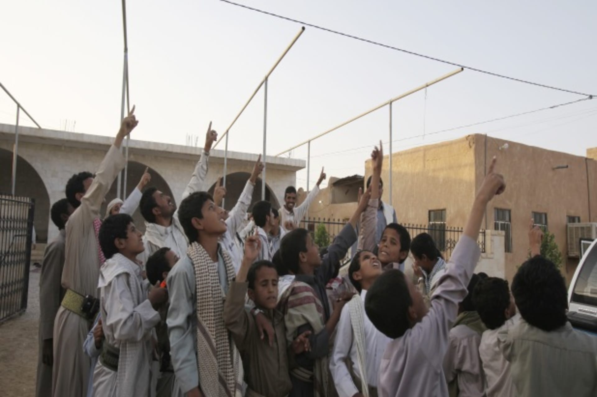 <p>Members of the Abida tribe point as they look for a drone aircraft flying at a high altitude over Wadi Abida in the eastern Yemeni province of Maarib (Courtesy Reuters/Khaled Abdullah Ali Al Mahdi).</p>
