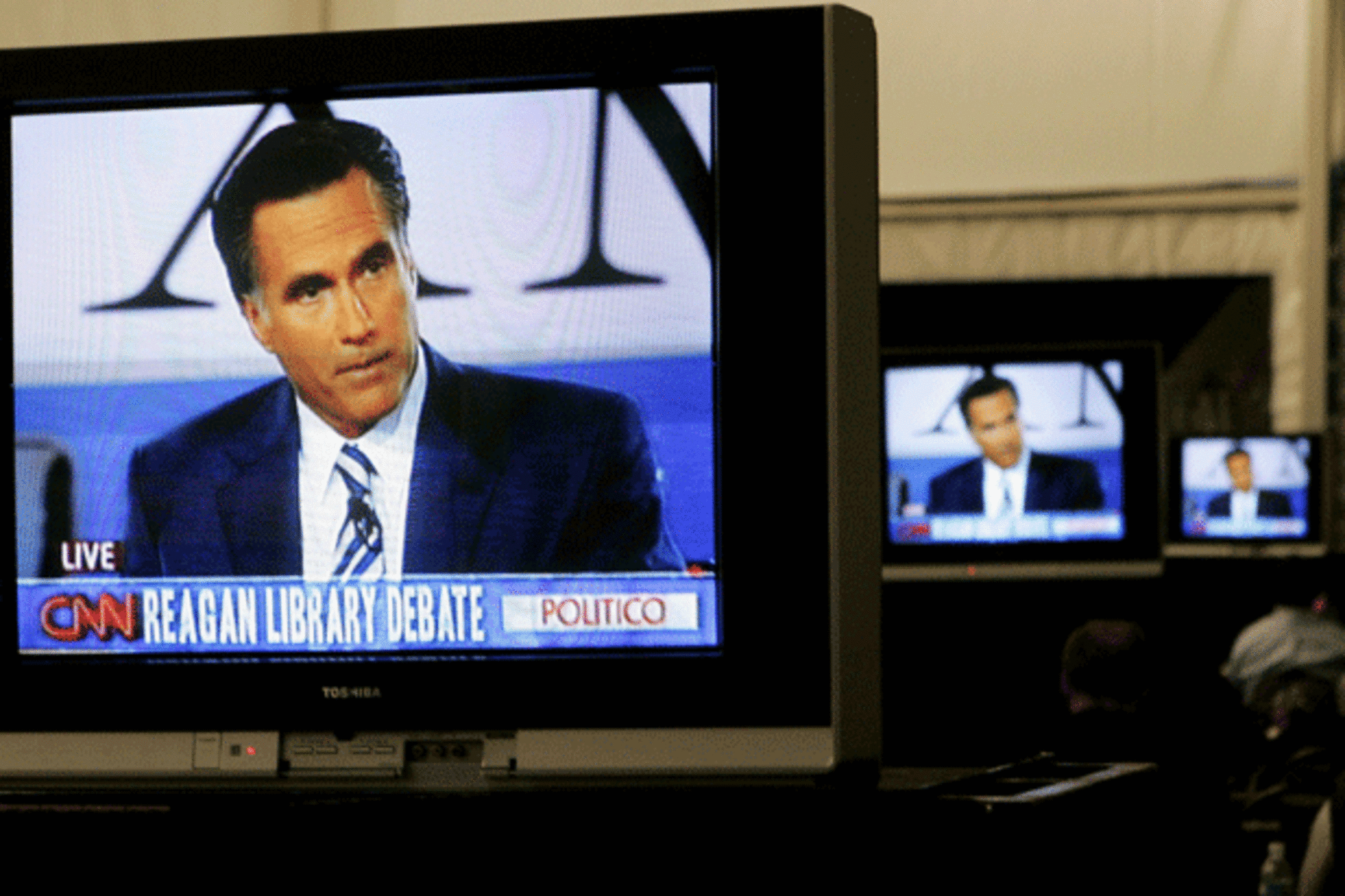 <p>Mitt Romney is shown on television monitors in the filing center during the Republican presidential debate at Ronald Reagan Presidential Library in Simi Valley, California. (Danny Moloshok/courtesy Reuters)</p>
