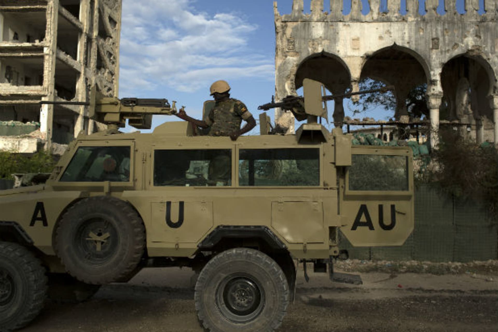<p>An African Union Mission in Somalia (AMISOM) soldier stands guard atop an armored vehicle in Mogadishu, Somalia, November 2013.</p>
